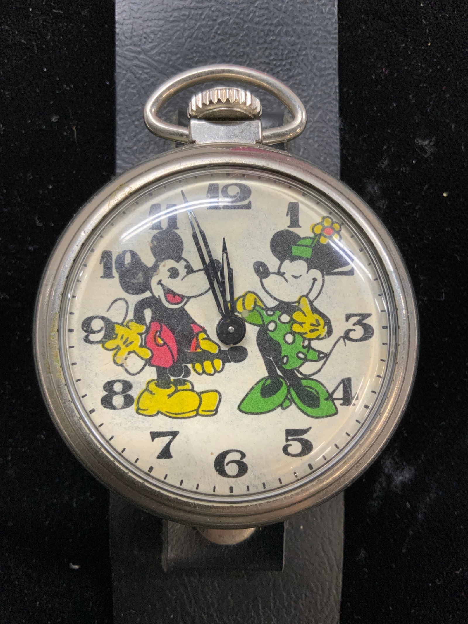 Retro Mickey & Minnie Mouse Fob Style Watch: 1930s Minnie and Mickey Mouse Fob Style Wide band Wristwatch with large Buckle ( 1 3/8 in. W) . image is risque in nature as Mickey is depicted holding his penis while Minnie lifts up her dress. Silve