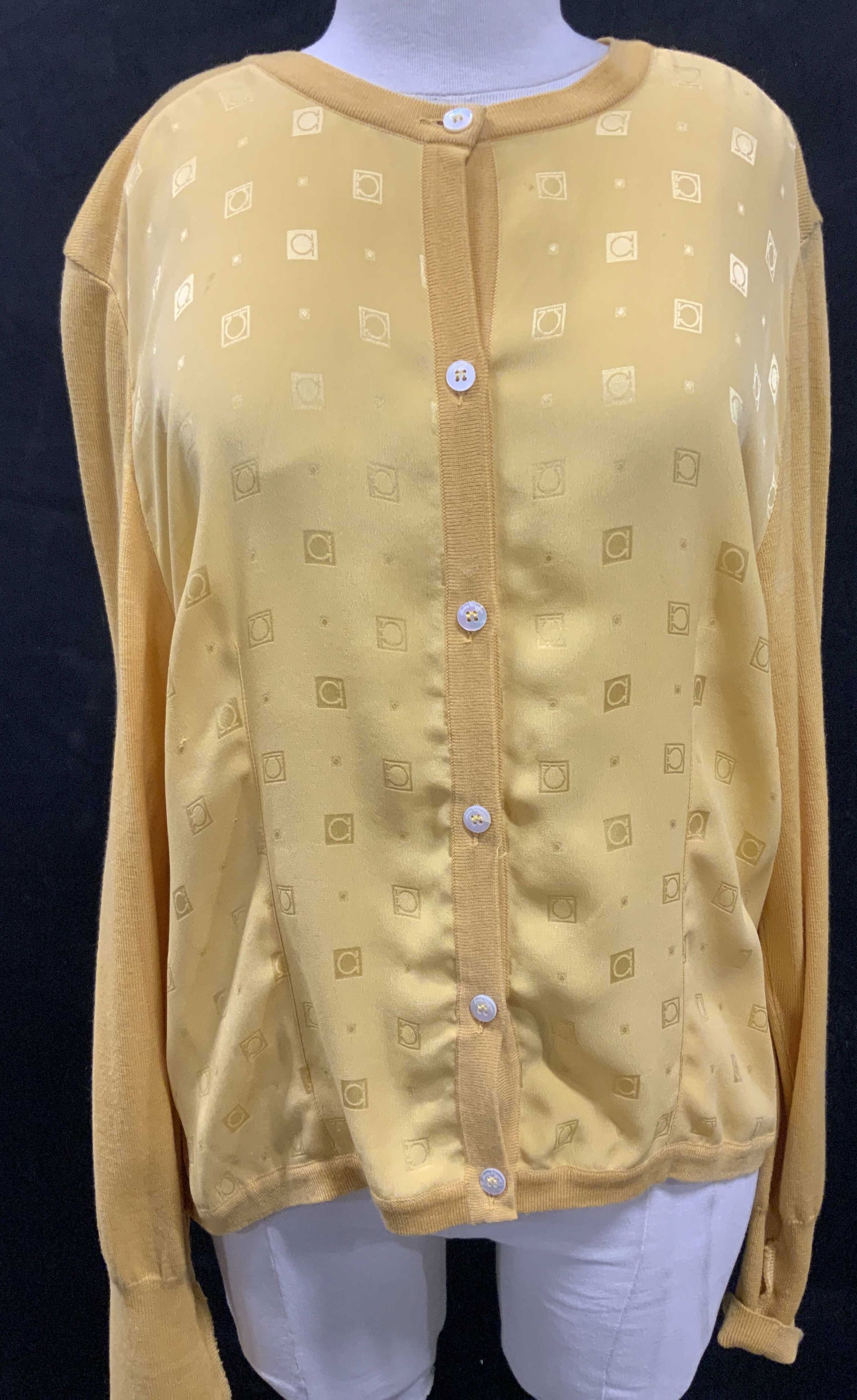 Salvatore FERRAGAMO Silk Knit Omega Cardigan, IT: Salvatore FERRAGAMO Luxury Cardigan in mustard. Possibly silk knit with a silk front side depicting the Omega symbol. Size Med. Hips 44 in. , 25 in. Long. Button closure., made in Italy. Original labe
