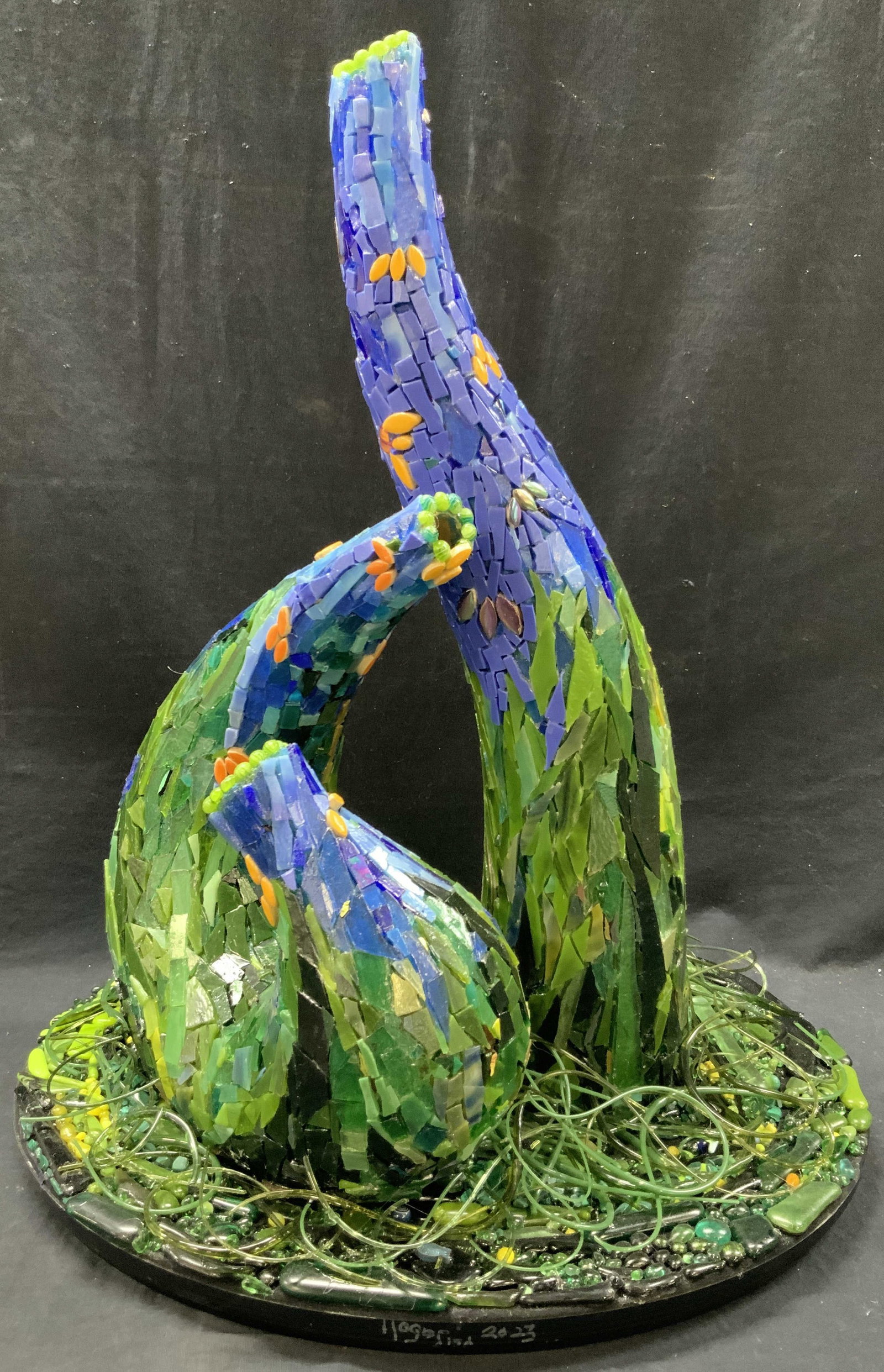22In Free Form Glass Mosaic Sculpture: Handmade Pound Ridge, New York glass artisan mosaic sculpture. Free form organic shaped pieces on base. Hues of green and blue, orange with millefiori motif. Piece has weight. Measures approx. 16 inch