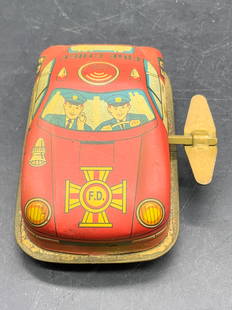 Vntg Russ Berrie & Co Fire Chief Wind Up Tin Car: A vintage Fire Chief wind up tin car toy. Appears to be Russ Berrie & Co, no apparent markings. Piece features images of two men driving the vehicle and the words FIRE CHIEF & F.D. Measures