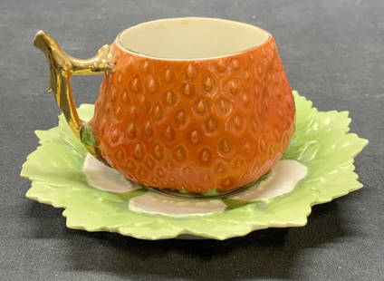 2 Antq Porcelain Strawberry Teacup & Saucer: Antique porcelain strawberry teacup and matching leaf saucer. Raises surface with gilt decoration. Style of Royal Bayreuth, unsigned. Teacup measures approx. 3.25 x 2.25 inches. Saucer measures