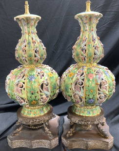 Pr Ornate Painted Porcelain Lamps w Koi Fish Base: Hand painted vintage porcelain lamps in the shape of a double gourd. Green flowers painted over solid gilt. Embossed and pierced porcelain set above a gilt metal base , 4 corner koi fish. European / V