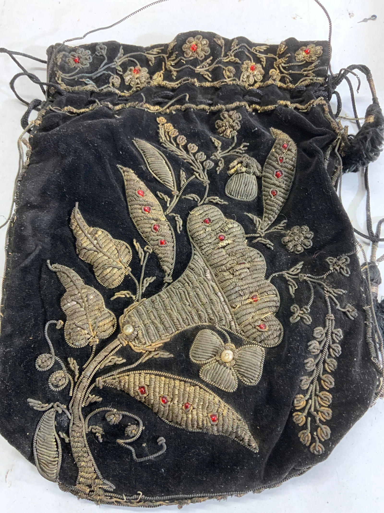 Antique Hand Embroidered Ladies Velvet Pouch: Black velvet antique pouch, hand embroidered with metal and red glass beads. Flower design. Wear to wire springs. Bag measures 8 x 5.25 in. Antique Hand embroidered ladies pouch, antique metal embroid