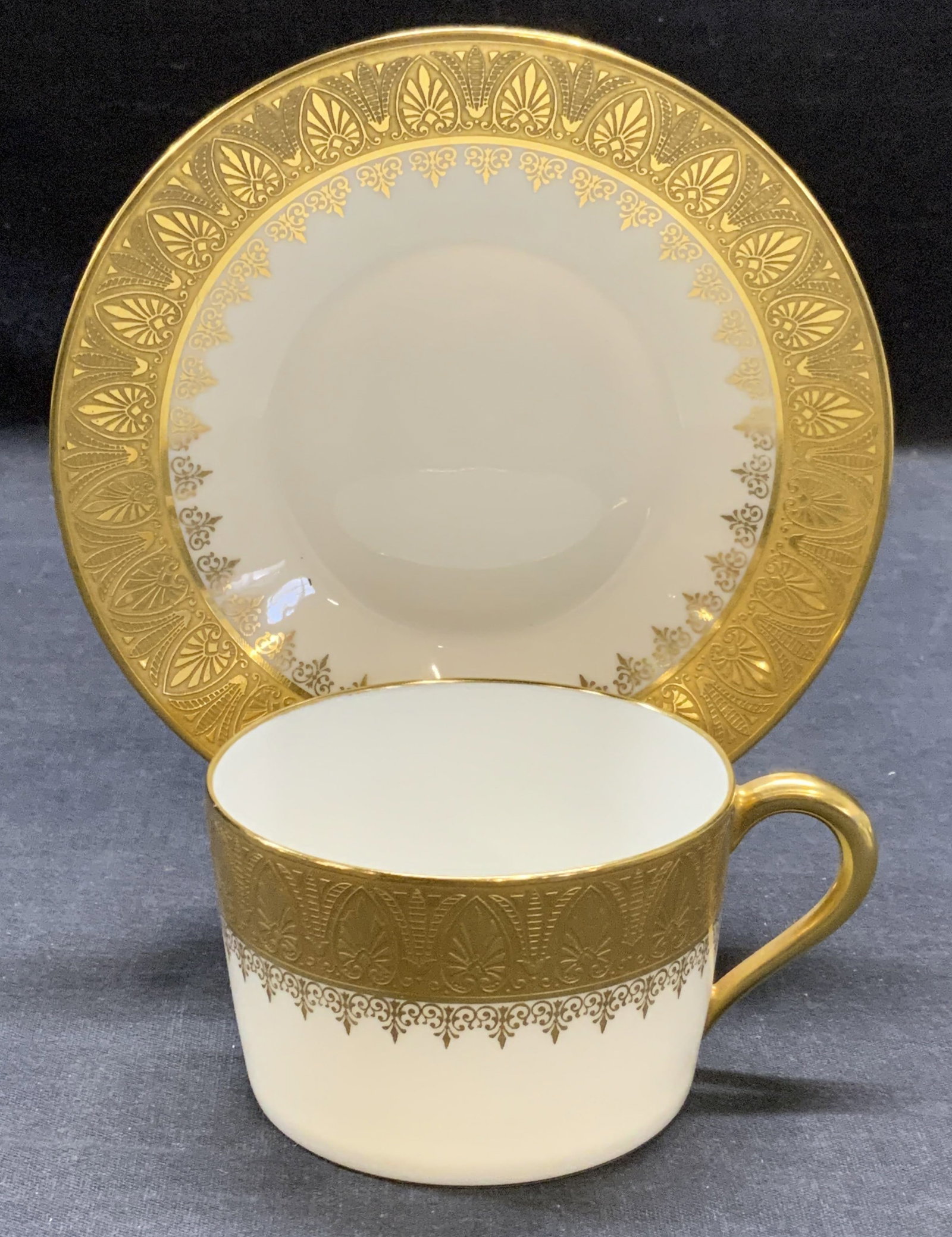 Vtg Ribes Limoges Fr Gilt Porcelain Cup & Saucer: Vintage Ribes Limoges gilt porcelain cup and saucer set. Gilt scroll motif with raised surface on cup and saucer. Trademarked to undersides. Made in France. Cup measures approx. 3.25 x 2.25 inches. Sa