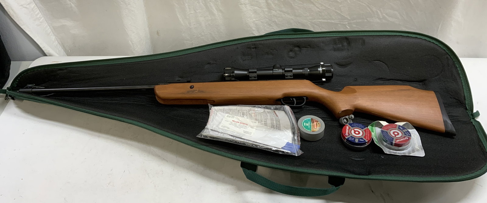 Crosman Quest 1000x C1K77X BB Gun: Crosman Quest 1000x model number C1K77X BB air rifle gun. Includes pellets and carrying case. Measures approx. 45 inches long. Piece has weight. Some surface wear including scratching observed. Not te