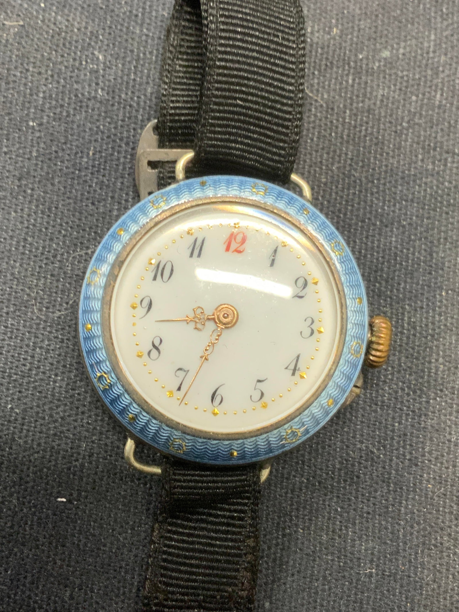Vintage Silver Tone Blue Enamel Watch: Vintage silver and blue enamel decorated watch with black strap. Watch face measures approx. 1 inch diameter. Includes jewelry box. Not tested for function. Some surface wear including scratching and 