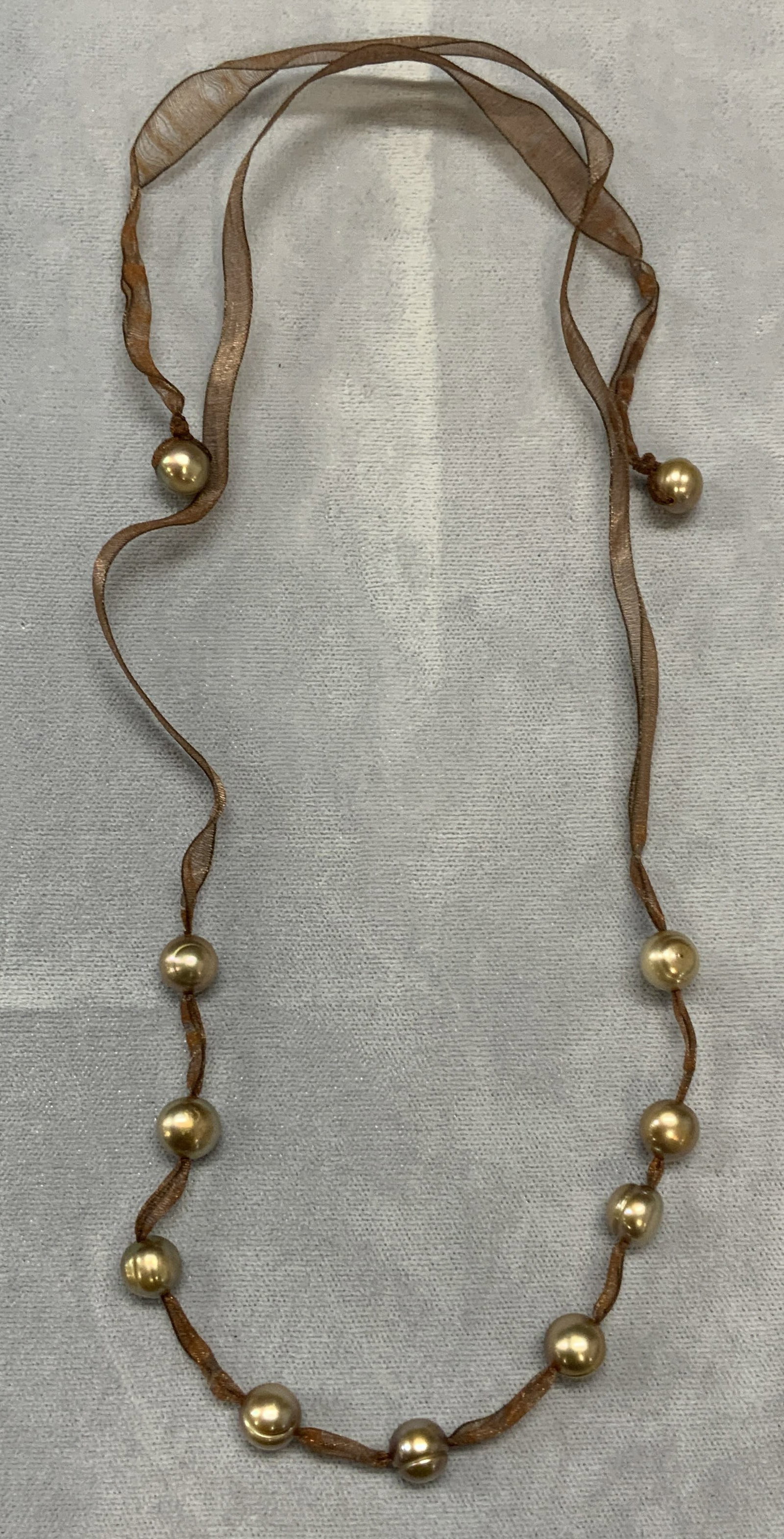 Vintage Brown Ribbon Pearl Necklace: Vintage necklace with brown ribbon and natural pearls. Drop length approx. 12 inches. Some surface wear including scratching observed. Estate jewelry, costume jewelry, fine jewelry, cocktail jewelry, 