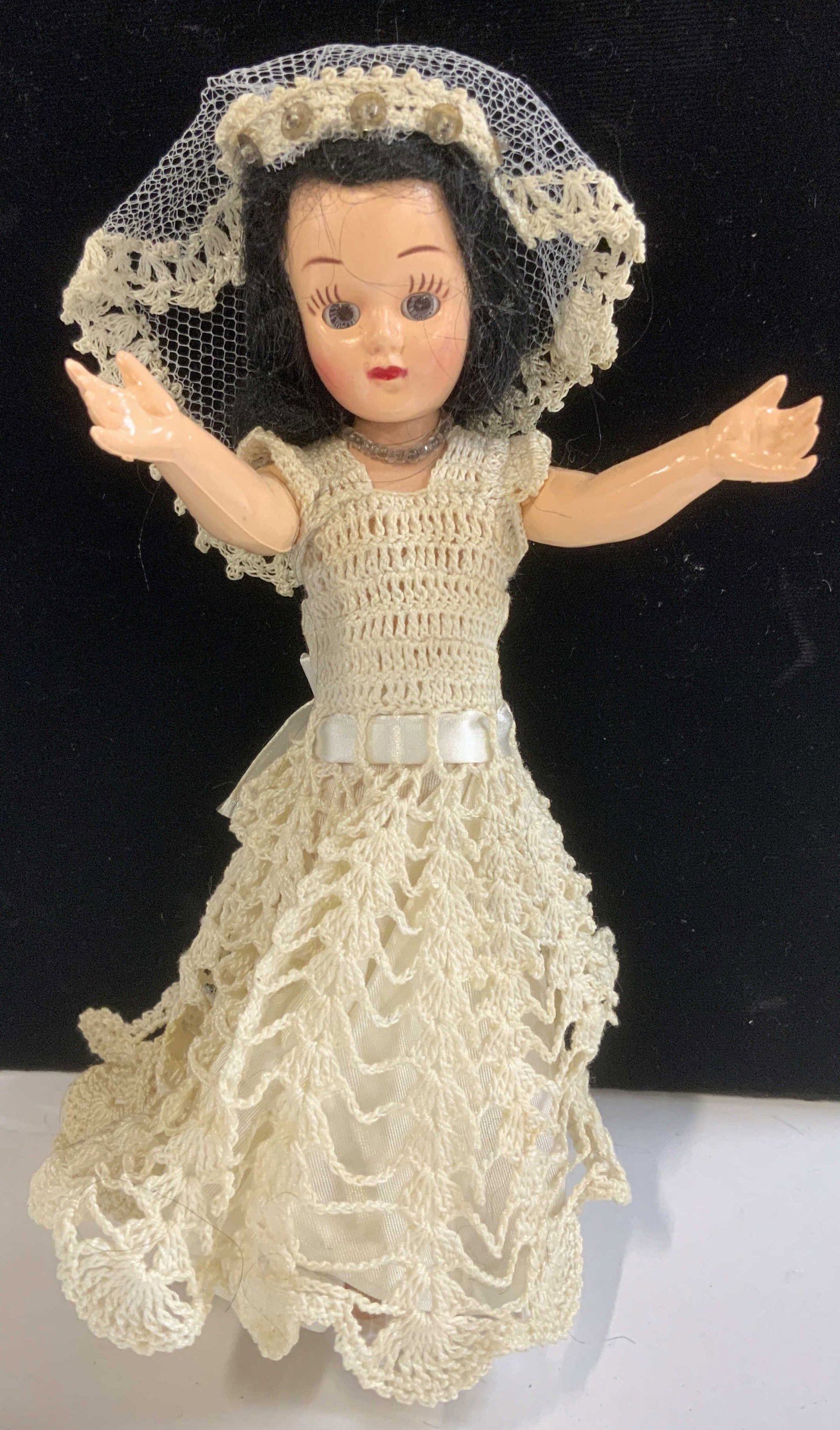 Vintage Doll w Crochet Wedding Dress & Veil: c. 1950s doll wearing a bridal dress, hand crochet with sash/ bow scalloped train, and wedding veil. Her eyes close when laid down. Arms move up and down. 8 x 2.5 in. Vintage doll, vintage toys, colle