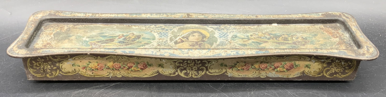 ROWNTREE Vintage Chocolate Candy Metal Tin: A vintage metal chocolate candy tin. Lidded. Features a woman to the center of the lid flanked by images of people in rowboats. Floral and geometric patterns throughout. Reverse reads ROWNTREE & CO. L