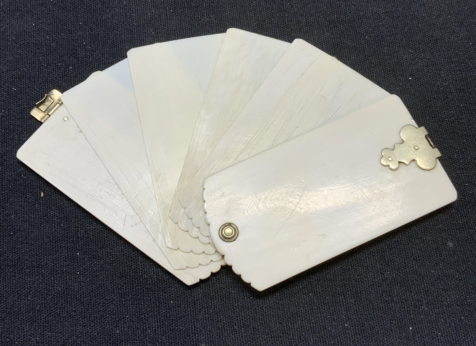 Antique Victorian Chatelaine Silver Bone Notepad: Antique Victorian bone notepad. Silver tone push clasp closure and hardware. Fanned pages. Possibly a chatelaine accessory attachment. Measures approx. 2 5/8 x 1 3/8 inches. Pencil residue observed. A