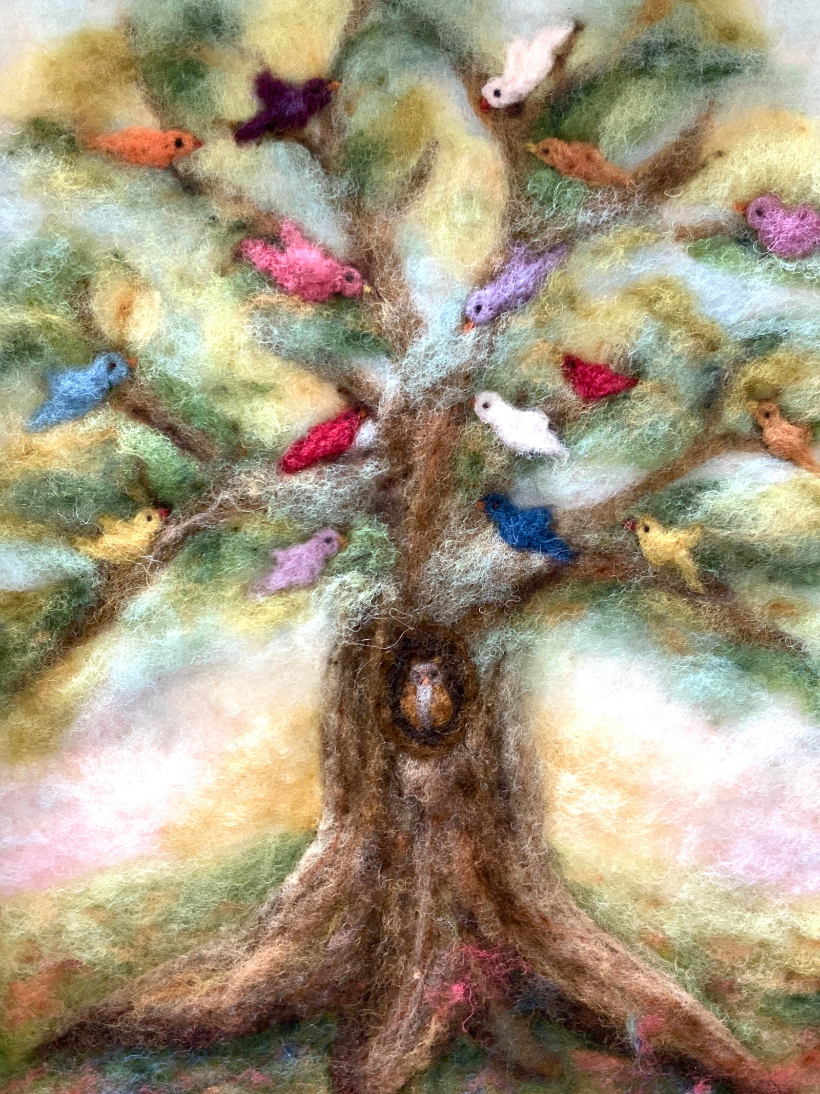 Judith Gilbert Hand Dyed Wool Picture: Marked on backside Judith Gilbert. Hand dyed wool picture, depicting a tree filled with birds in the branches and an owl in the trunk. Framed in a light toned wooden frame, approx 16 x 13 inches windo