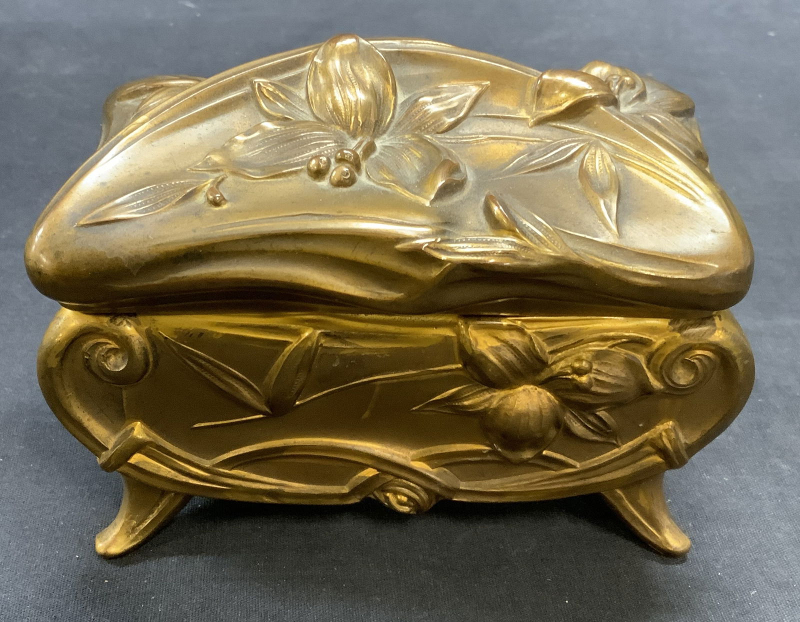 Vintage Gilt Brass Floral Dresser Box: Vintage gilt brass dresser box with embossed raised floral motif. Fabric lined interior. Measures approx. 5.5 x 3 x 4 inches. Piece has weight. Surface wear including scratching and loss to gilt. Tear