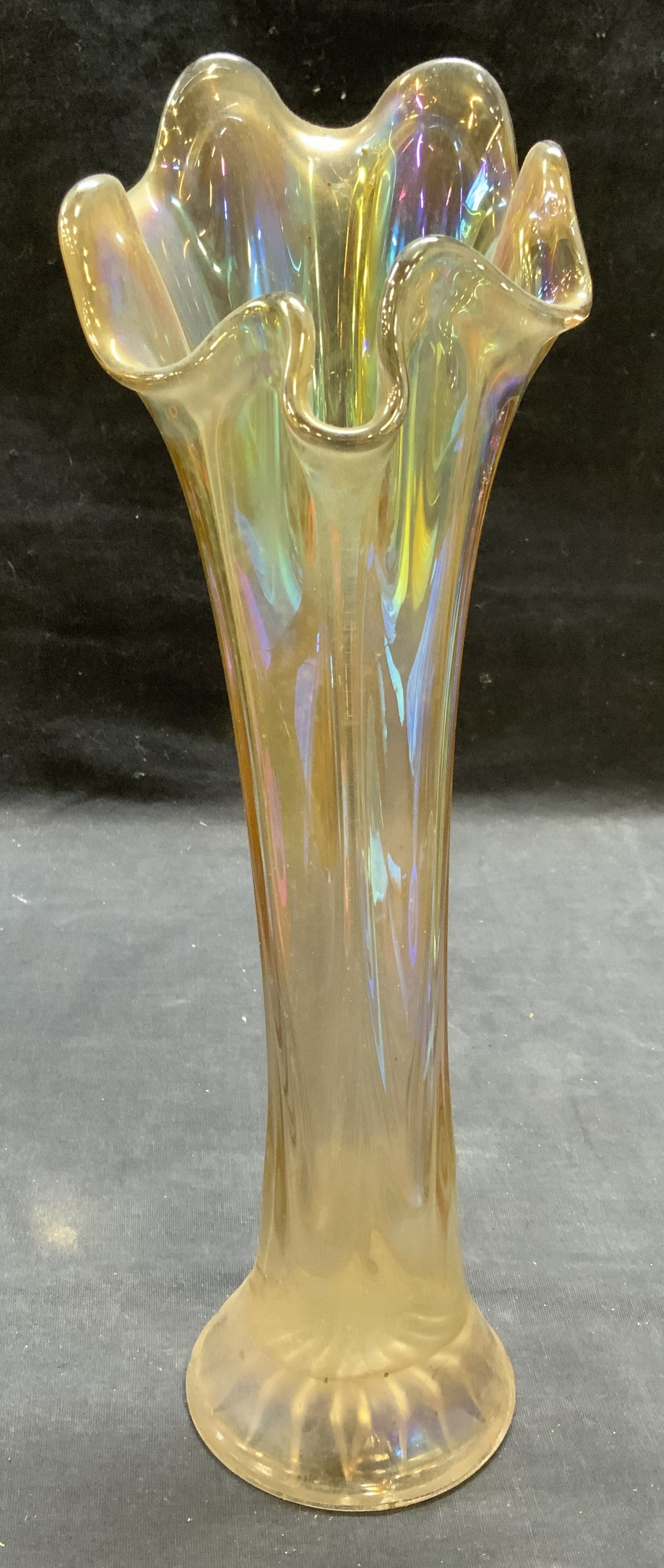 Amber Carnival Glass Iridescent Swung Vase: Amber toned carnival glass iridescent swung style vase. Measures approx. 4.25 x 12.5 inches. Some surface wear including scratching observed. Carnival glass, swung glass, carnival glass vase, swung gl