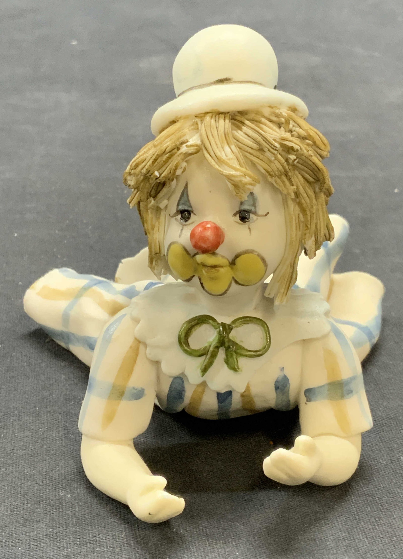 Signed JS Porcelain Clown Baby Figural: Signed JS porcelain clown baby figural in white and blue. Signed to underside. Measures approx. 4.75 x 3.75 x 3.5 inches. Signed to underside. Some surface wear including scratching observed. Clown fi