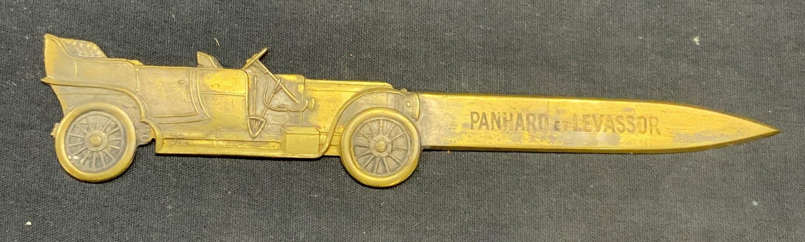 Panhard Levassor Brass Automobile Letter Opener: Vintage Panhard et Levassor brass letter opener with embossed automobile motif. Measures approx. 8 inches long. Surface wear including scratching and loss to finish observed. Panhard and Levassor, Pan