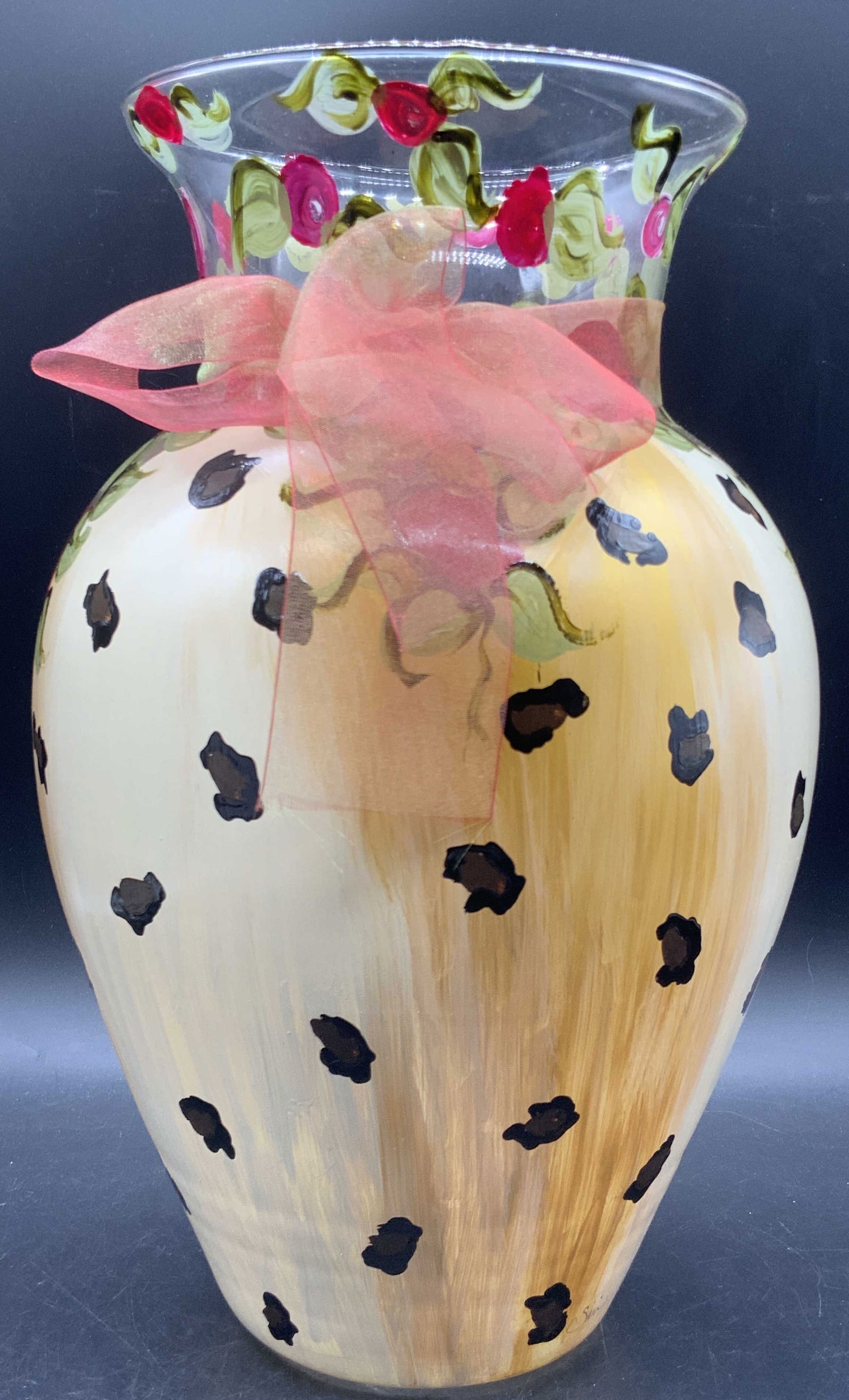 IRIS BY DESIGN Hand Painted Glass Vase: A clear glass vase hand painted with florals and leopard patterns. Ribbon accent to the neck. Signed towards base. Sticker to the underside reads IRIS BY DESIGN. Measures approx. 13H x 7.5W in. Some s