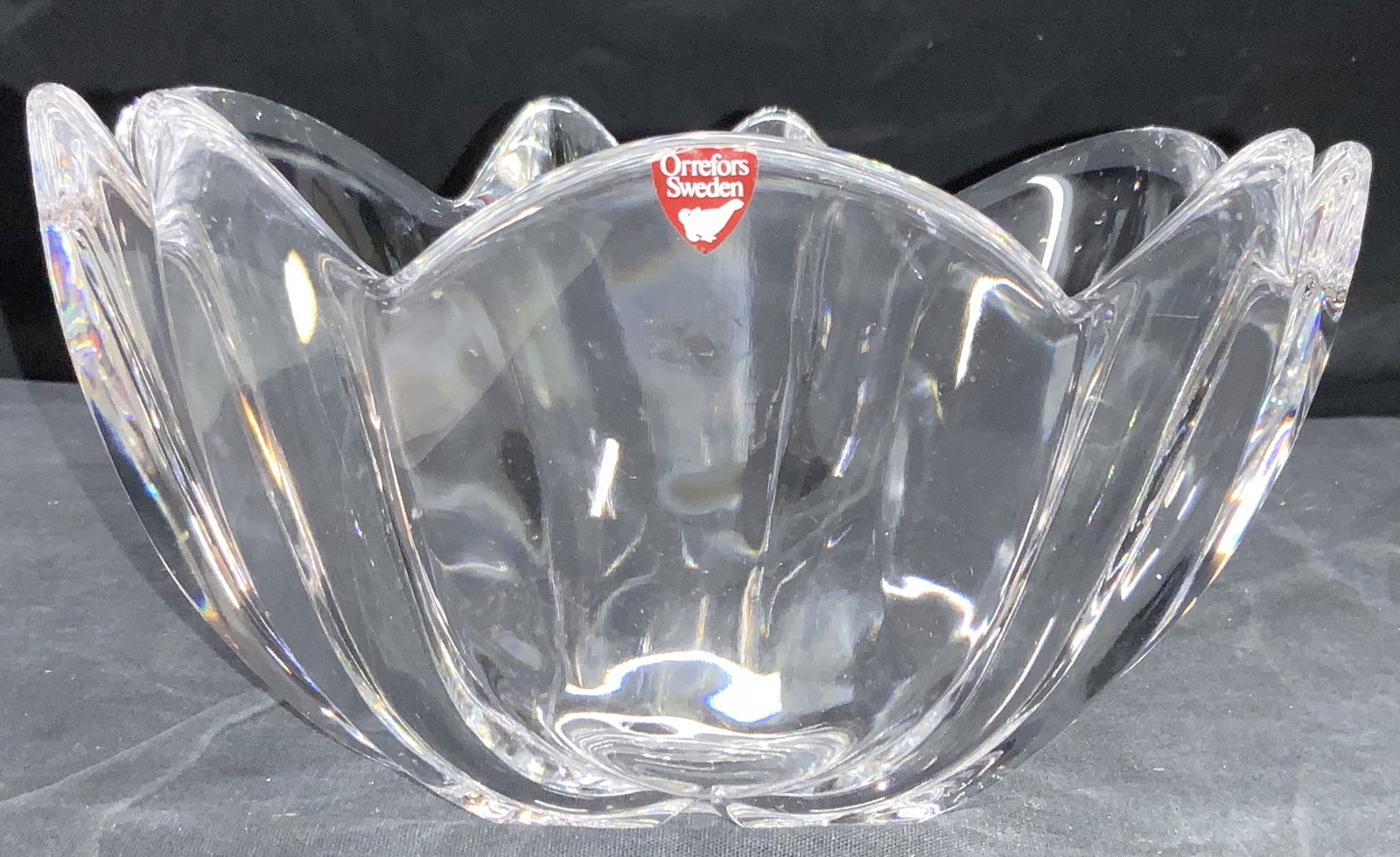 ORREFORS Crystal Tulip Bowl, Sweden: A clear crystal bowl, crafted to resemble a Tulip. Sticker on side reads Orrefors Sweden and underside is etched Orrefors. Approximately 4.25 inches tall and 8 inch diameter. Property of Palm Beach, F