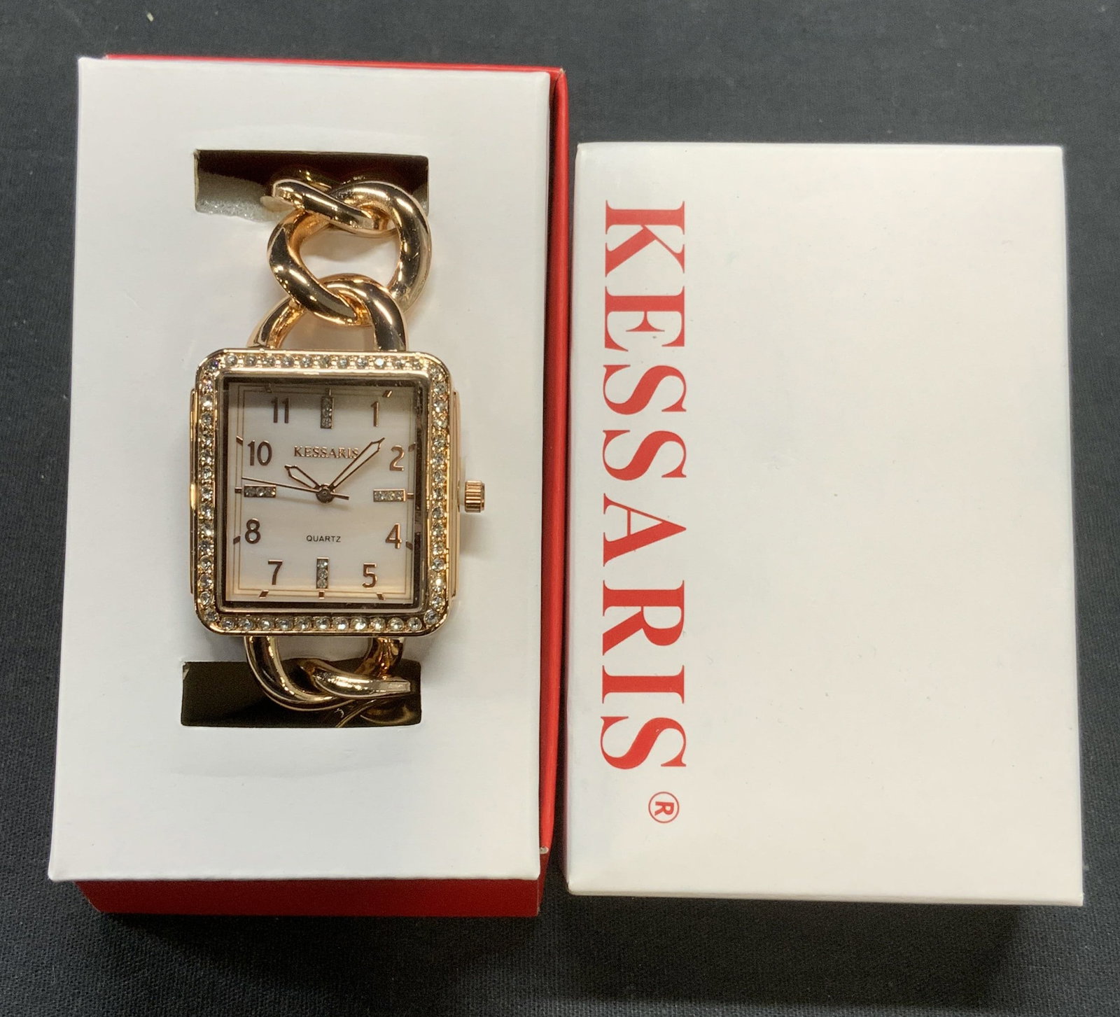 Kessaris Rose Gold Tn Crystal Watch NIB: Kessaris rose gold tone watch with crystal decoration. Trademarked on watch face and band. New in box. Measures approx. 7.25 inches long. Not tested for function. Estate jewelry, costume jewelry, cock