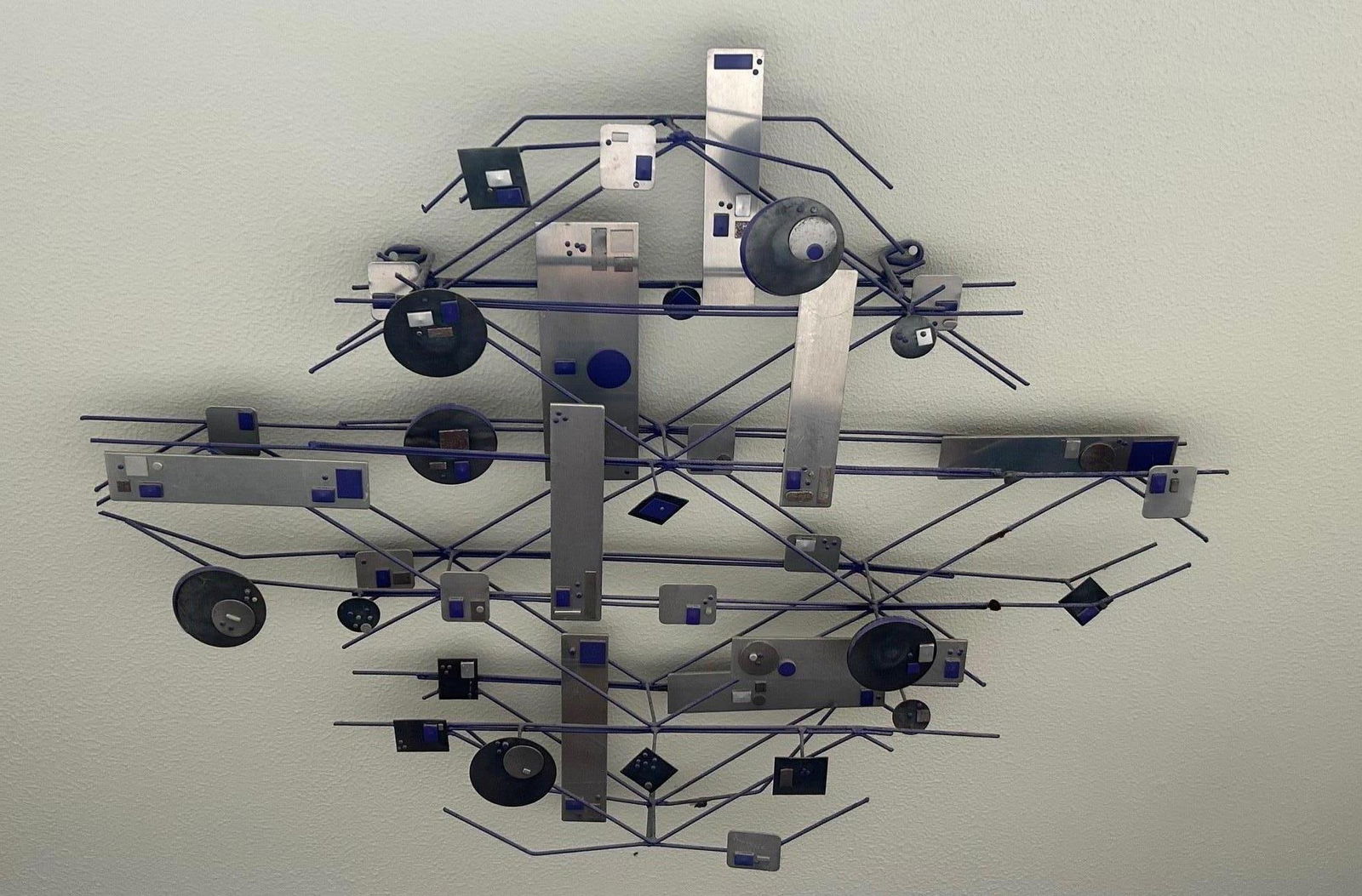 Mid Century Style Welded Metal Geometric Sculpture: Mid century style welded metal sculpture made of purple toned metal posts with white metal geometric tiles, with purple geometric tiles throughout. Approx 29 x 40 inches Evident losses to metal tiles