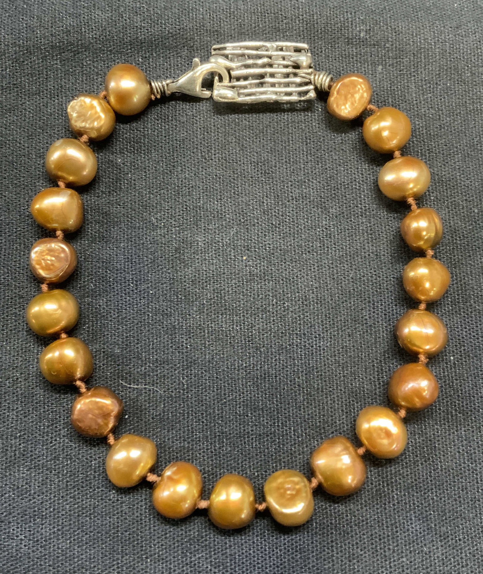 Sterling Silver Chocolate Pearl Bracelet: Sterling silver and chocolate pearl beaded bracelet. Marked 925, IK. Measures approx. 7.5 inches long. Some surface wear including scratching observed. Estate jewelry, fine jewelry, cocktail jewelry, 