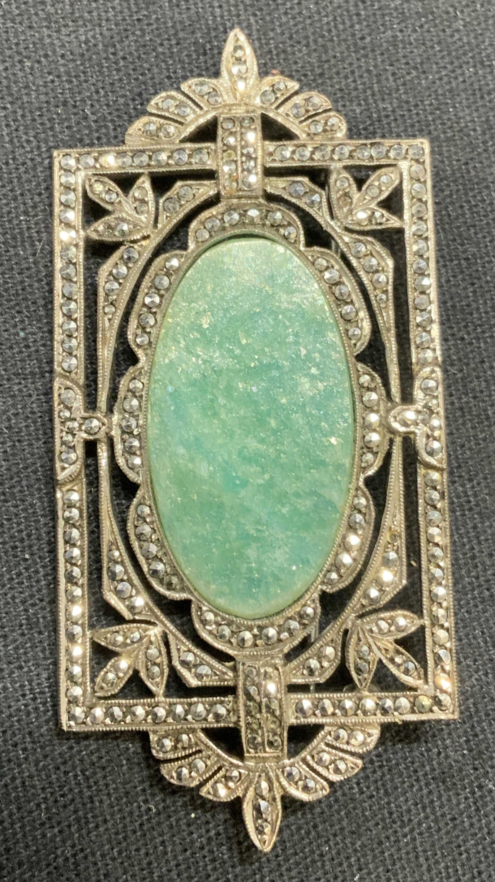 Sgn Sterling Silver Marcasite & Blue Stone Brooch: Signed sterling silver, marcasite, and blue stone decorated brooch. Marked sterling, signed illegibly to underside. Hinge pin to underside. Total weight 14.2 grams. Measures approx. 2 3/8 x 1 1/8 inch