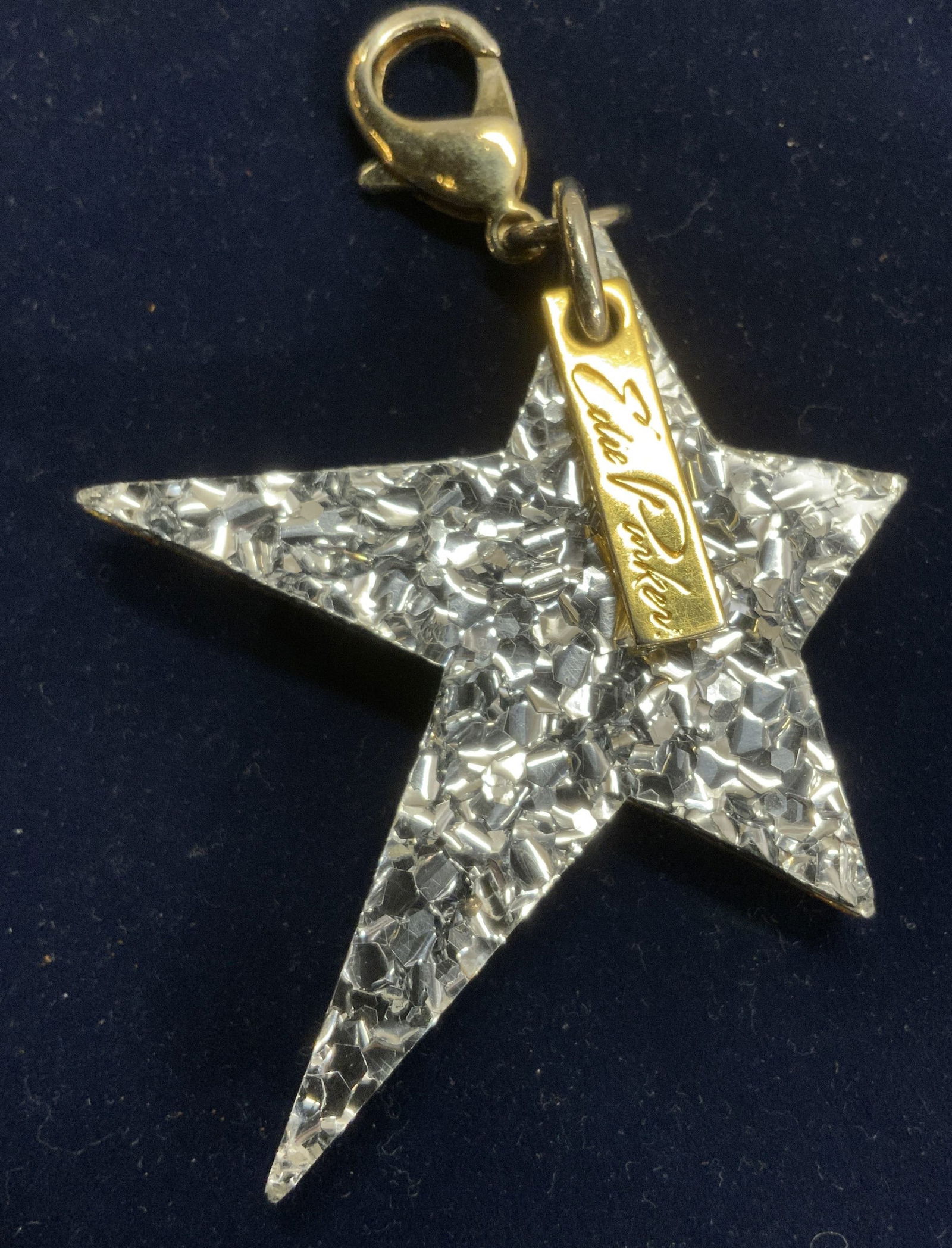 Edie Parker Lucite Metallic Star Keychain/Charm: Luxury Edie Parker 4.5 in. Long bag charm/ keychain charm, etc. lucite with gold metallic confetti on one side and silver metallic confetti on the other side. Signed charm Edie Parker. 2.5 in. Wide. c