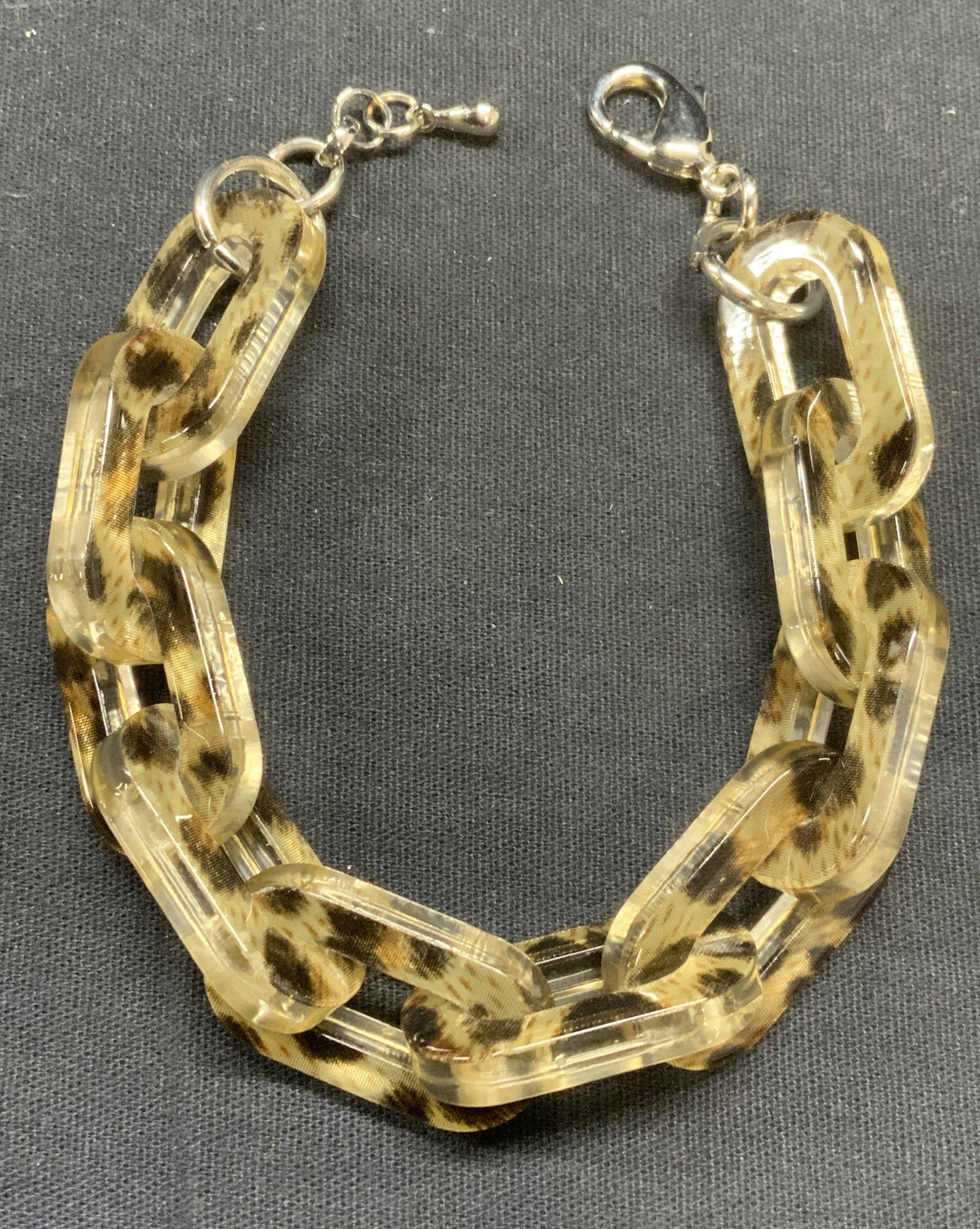 Animal Print Lucite Chain Link Bracelet: Animal print lucite chain link bracelet. Measures approx. 8.25 inches long. Some scratching observed. Estate jewelry, costume jewelry, fashion jewelry, cocktail jewelry, accessories, fashion accessori