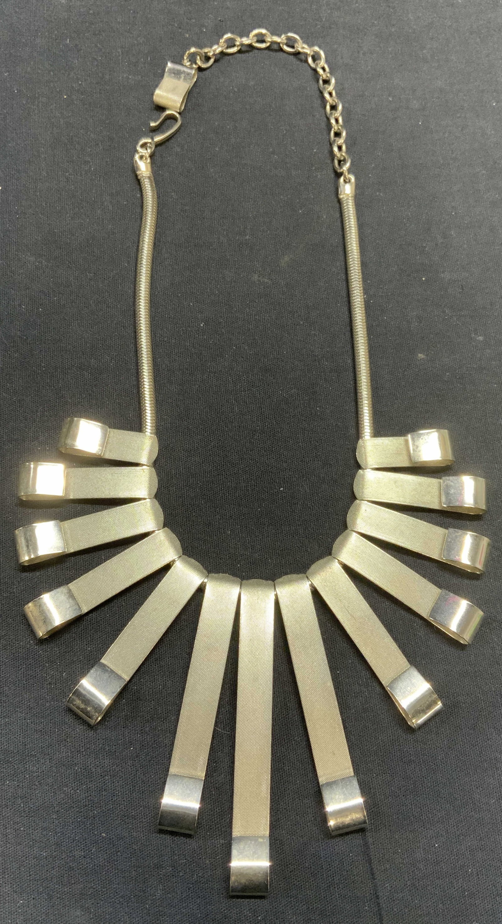 Silver Tone Radiating Pendant Necklace: Silver tone necklace with radiating pendants. Drop length approx. 7.5 inches. Longest pendant approx. 3.25 inches long. Some scratching observed. Estate jewelry, costume jewelry, cocktail jewelry, fas