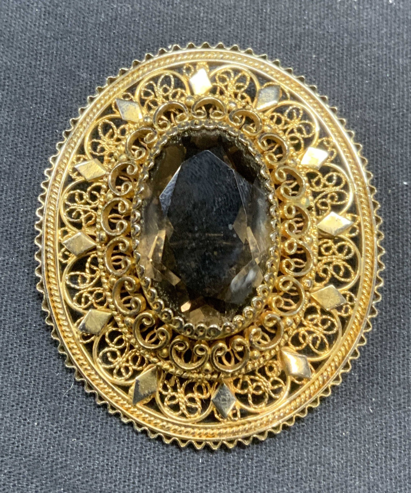 Gold Vermeil Sterling Silver Brown Gem Brooch: Gold vermeil over sterling silver filigree brooch with brown toned faceted gemstone. Tests for sterling using PuriTEST kit. Measures approx. 2.25 x 2 inches. Total weight 31.7 grams. Some scratching o