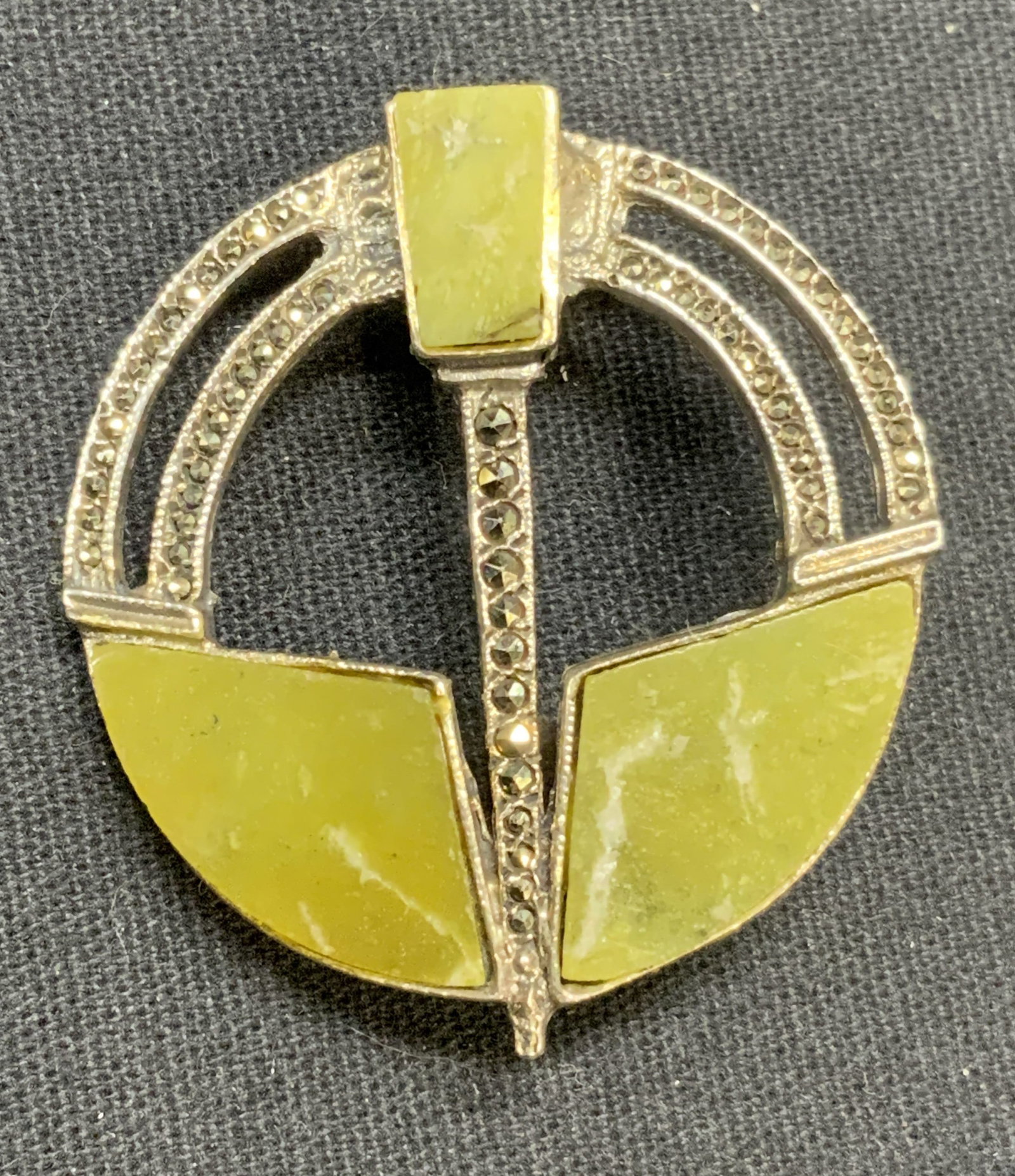 Signed .999 Fine Silver & Green Stone Brooch: Signed .999 fine silver brooch with marcasite and green stone decoration. Signed illegibly to underside, marked 999. Hinge pin to underside. Measures approx. 1.5 x 1 3/8 inches. Total weight 10.6 gram