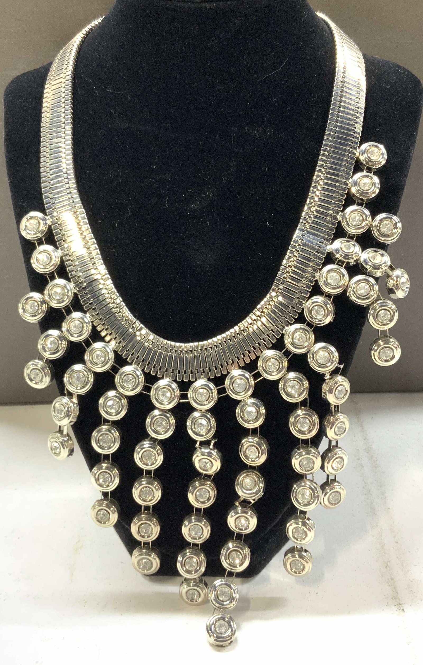 Silver tone Crystal Bib Necklace: Dangling bob necklace with wide flat chain, Bib decor has a 4 in. Length. A few kinks in the connector links. Lacks 1 strand. Extendable chain, 7 in drop is the shortest. Chunky Bib Necklace, Luxury S