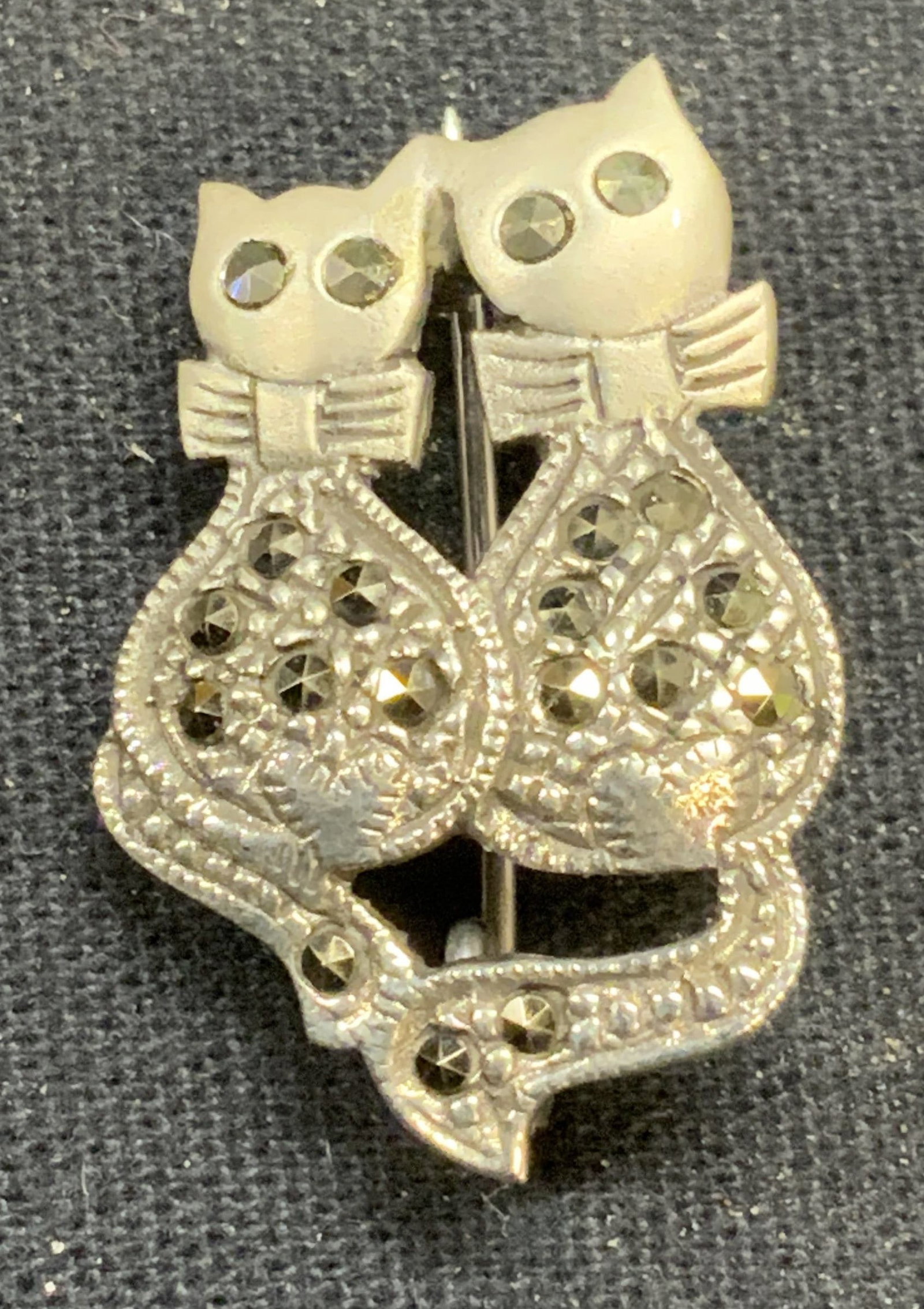 Sterling Silver Marcasite Cat Brooch: Sterling silver and marcasite decorated cat brooch. Marked 925. Hinge pin to underside. Measures approx. 1 x .75 inches. Total weight 4.3 grams. Some scratching observed. Estate jewelry, fine jewelry,