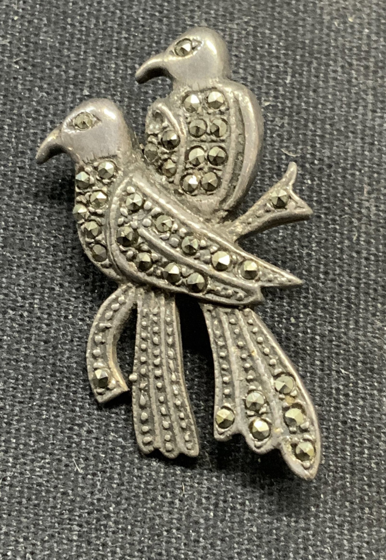 Vintage Sterling Silver Marcasite Dove Brooch: Vintage sterling silver and marcasite decorated dove brooch. Marked 925 to underside. hinge pin to underside. Measures approx. 1.25 x .75 inches. Total weight 5.6 grams. Some scratching observed. Esta