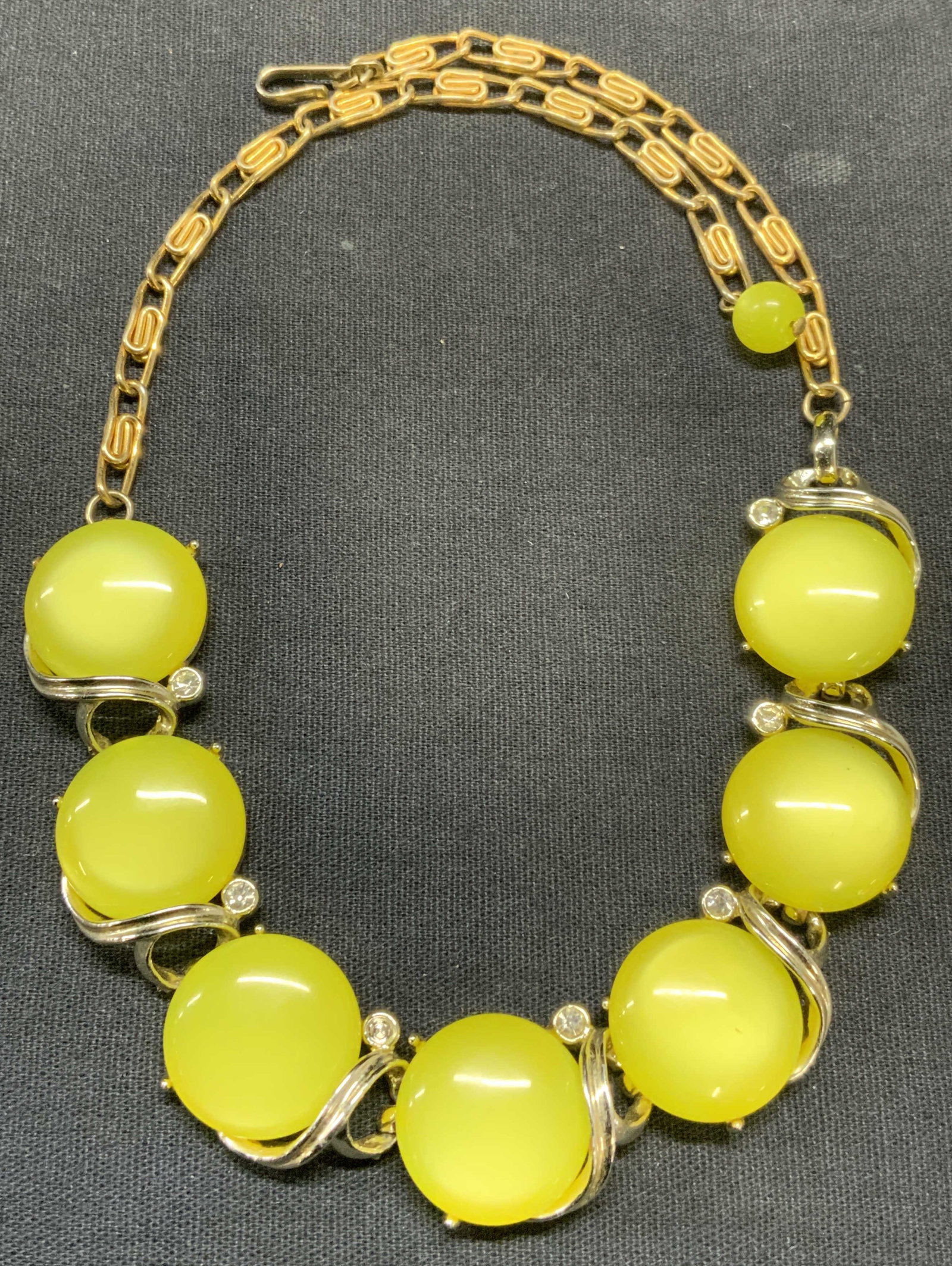 Vintage Lisner Yellow Cabochon & Crystal Necklace: Vintage Lisner gold tone necklace with yellow cabochon and colorless crystal decoration. Signed on clasp. Drop length approx. 6.5 inches. Some scratching observed. 1 crystal needs replacement. Estate 