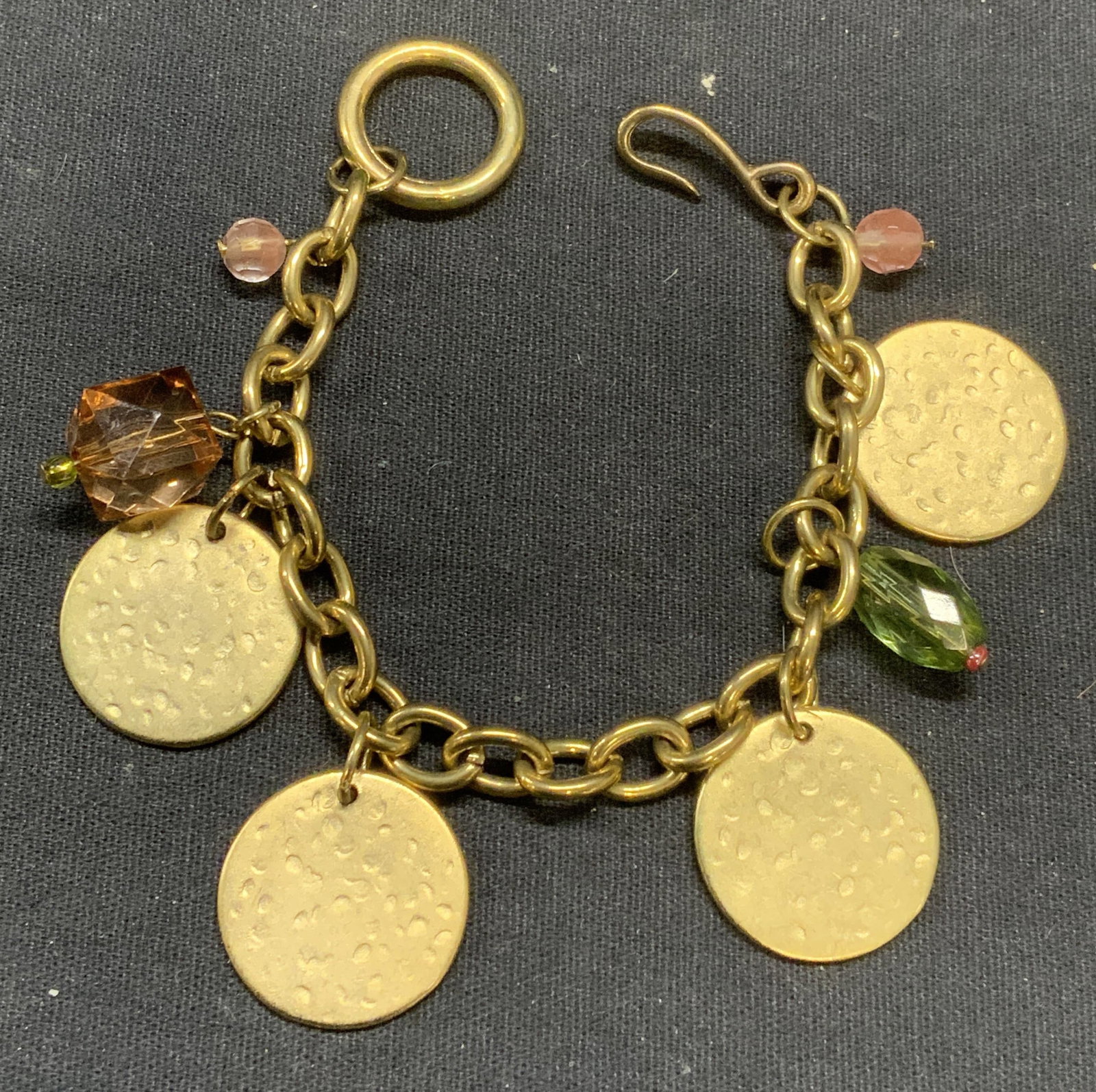 Gold Tone Disc & Crystal Bracelet: Gold tone chain bracelet with disc and pink and green toned crystal beads. Measures approx. 6.5 inches long. Some scratching observed. Estate jewelry, costume jewelry, cocktail jewelry, fashion jewelr
