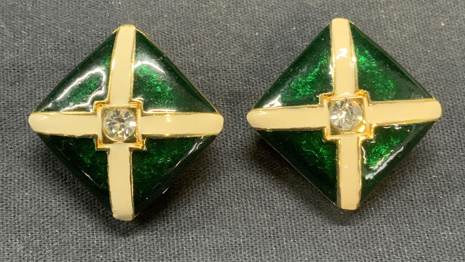 Attr Toni Laura Gold Tn Crystal Enamel Earrings: Attributed to Toni Laura gold tone earrings with green and white enamel and colorless crystal decoration. Unsigned. Clip on backing. Measure approx. 1 x 1 inches. Some scratching observed. Estate jewe
