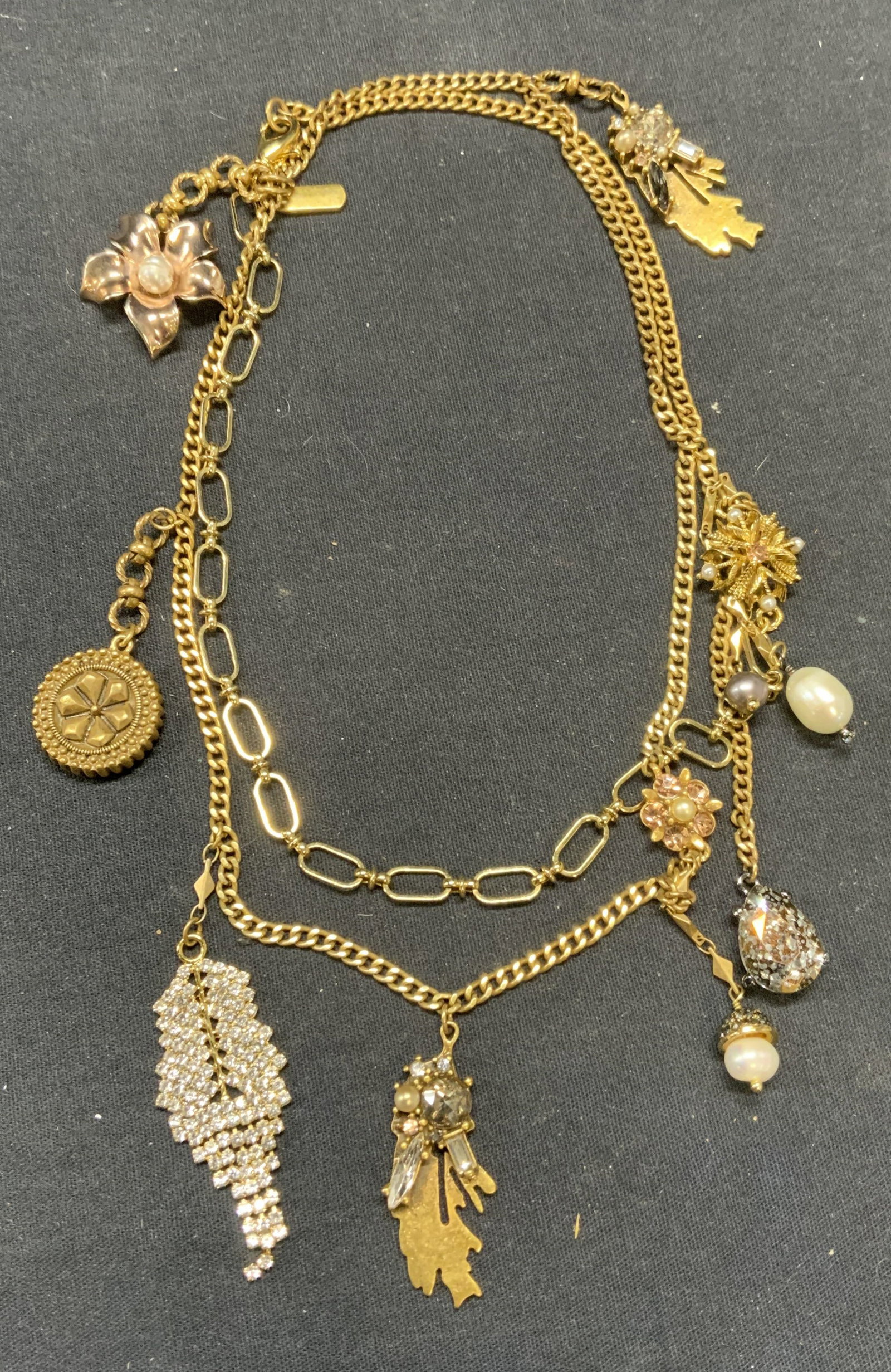 BADGLEY MISCHKA Gold Tn Crystal Pendant Necklace: BADGLEY MISCHKA gold tone crystal and pearl accent decorated pendant necklace with botanical motif. Signed on hang tag. Drop length approx. 18 inches. Some scratching observed. Estate jewelry, costume