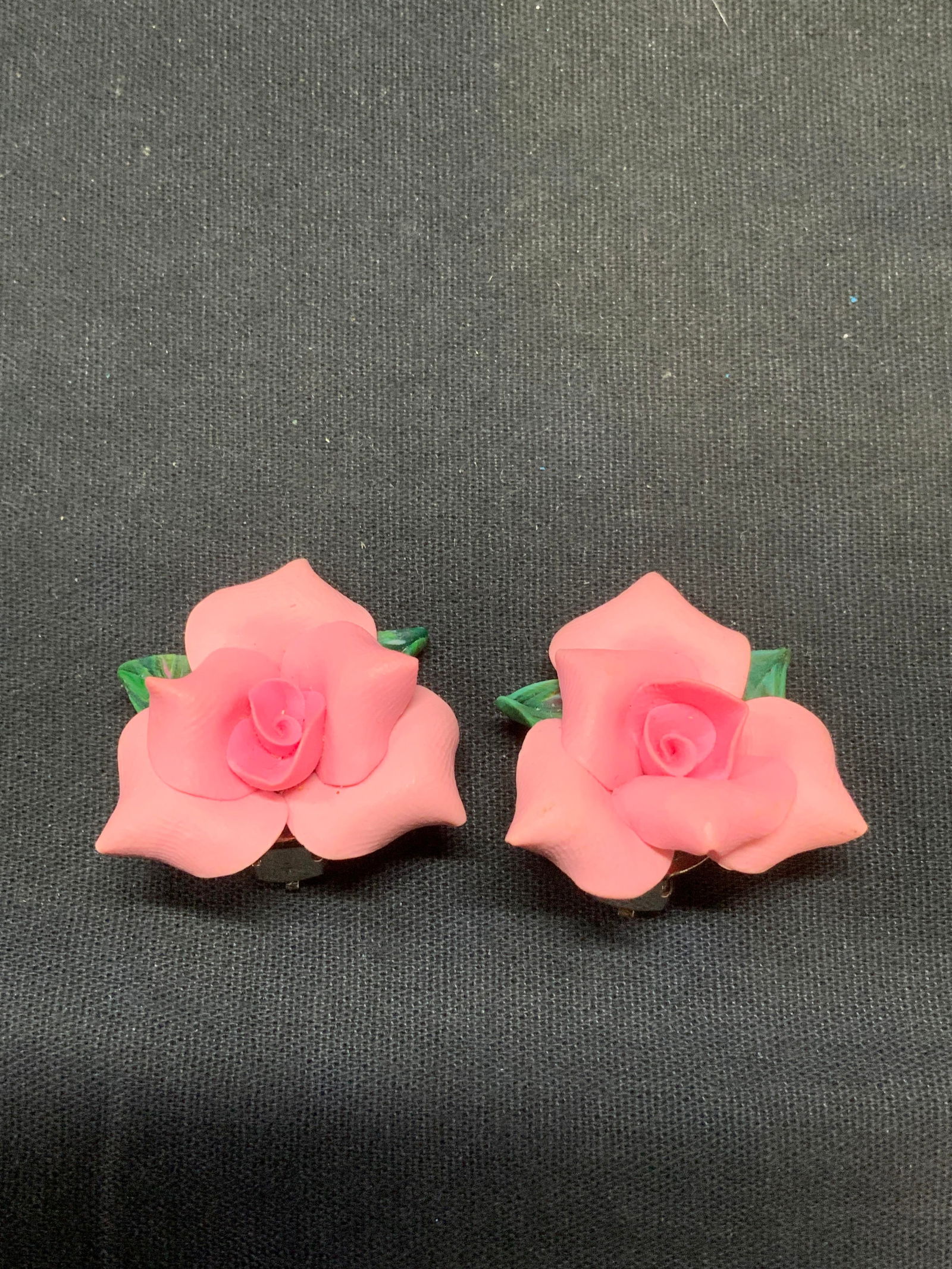 Handmade Pink Rose Flower Earrings: Handmade clay earrings. Pink rose form. Clip on backing. Measure approx. 1.25 x 1.25 inches. Some surface wear including scratching observed. Estate jewelry, costume jewelry, fashion jewelry, cocktail