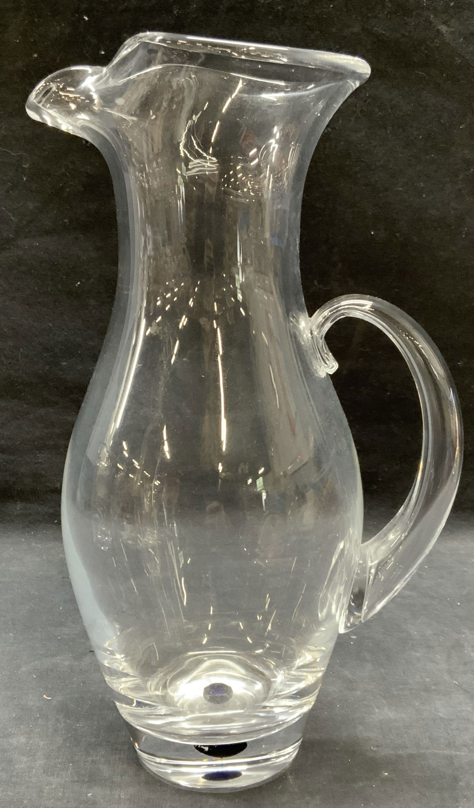 ORREFORS Hand Blown Crystal Pitcher: ORREFORS hand blown crystal pitcher. Signed to underside. Measures approx. 4.5 x 11.5 inches. Thick walled crystal, piece has weight. Some surface wear including scratching observed. ORREFORS, ORREFOR
