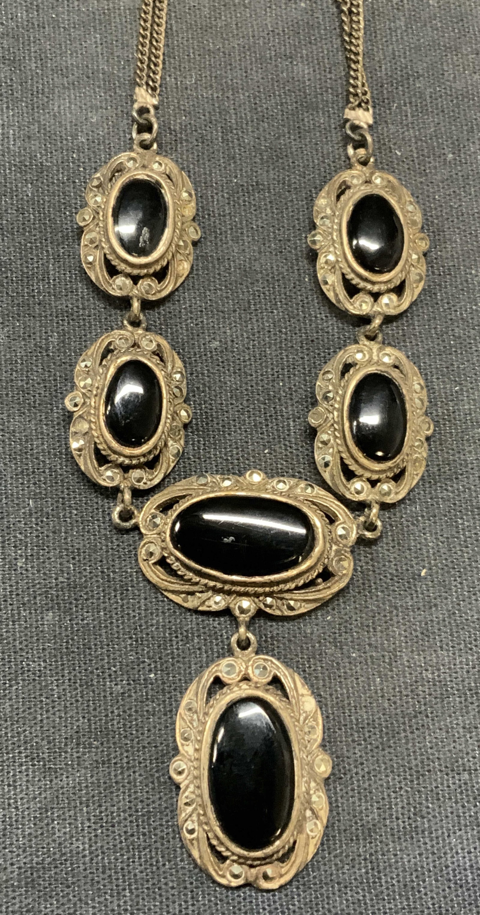 Vtg Sterling Silver Black Stone Pendant Necklace: Vintage sterling silver necklace with black stone and marcasite decorated pendants. Marked 925 on clasp. Drop length approx. 9 inches. Total weight 21.4 grams. Some surface wear including scratching o