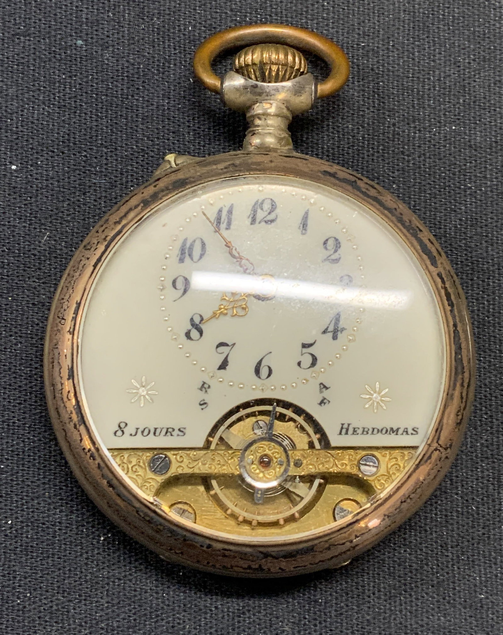 Vintage French 8 Day Pocket Watch: Vintage, possibly antique, gold tone French 8 day pocket watch. Marked 8 Jour, Hebdomas on face. Writing in French to interior case. Measures approx. 2 inches wide. Not tested for function. Some surfa