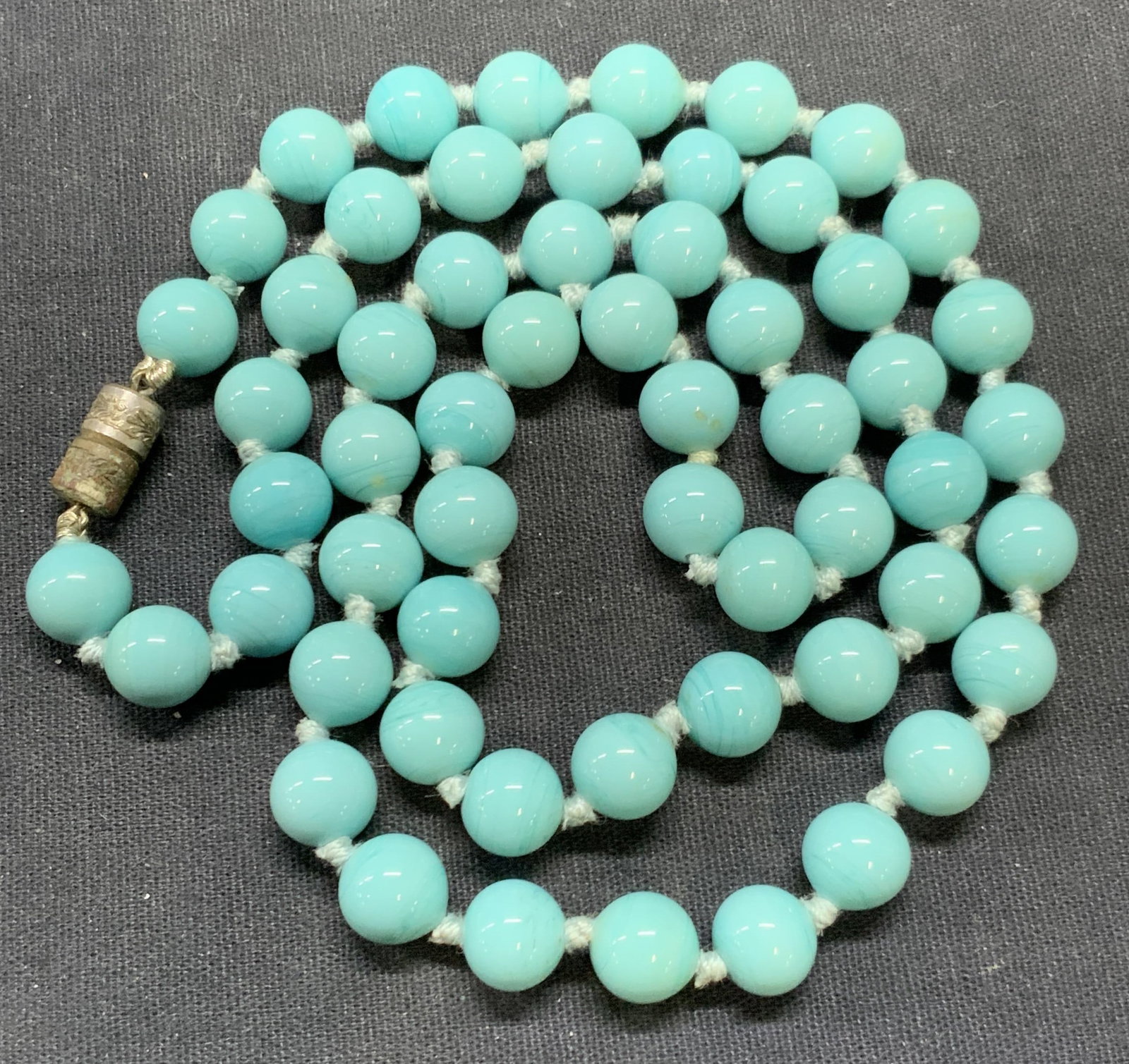 Vintage Blue Art Glass Swirl Beaded Necklace: Vintage blue toned art glass beaded necklace with swirl detail. Drop length approx. 12.5 inches. Some surface wear including scratching observed. Estate jewelry, costume jewelry, cocktail jewelry, fas