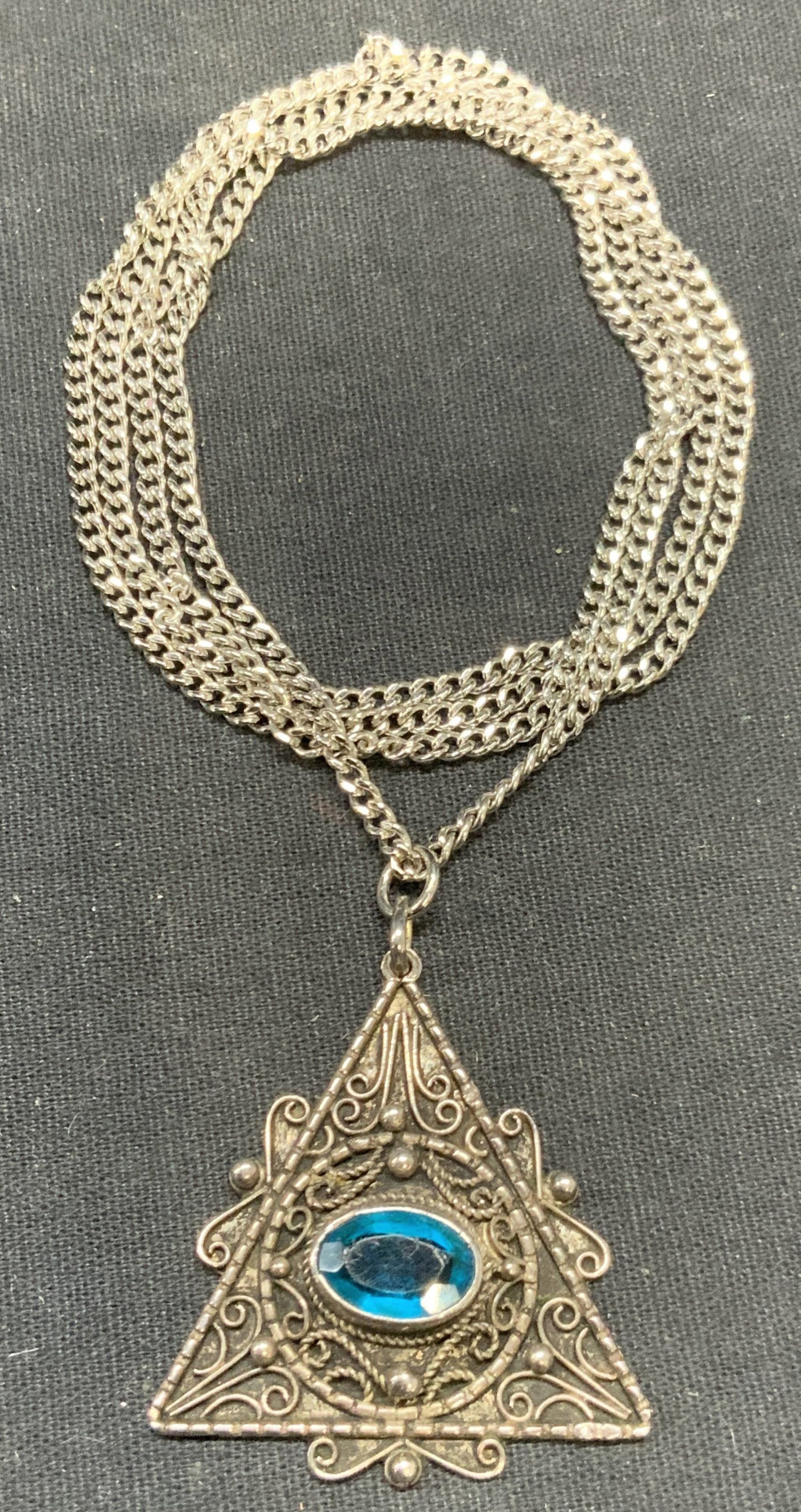 Vintage Sterling Silver Crystal Pendant Necklace: Vintage sterling silver pendant necklace with blue crystal decoration. Filigree pendant. Drop length approx. 15 inches. Pendant measures approx. 1.5 inches long. Total weight 18.2 grams. Tests for ste