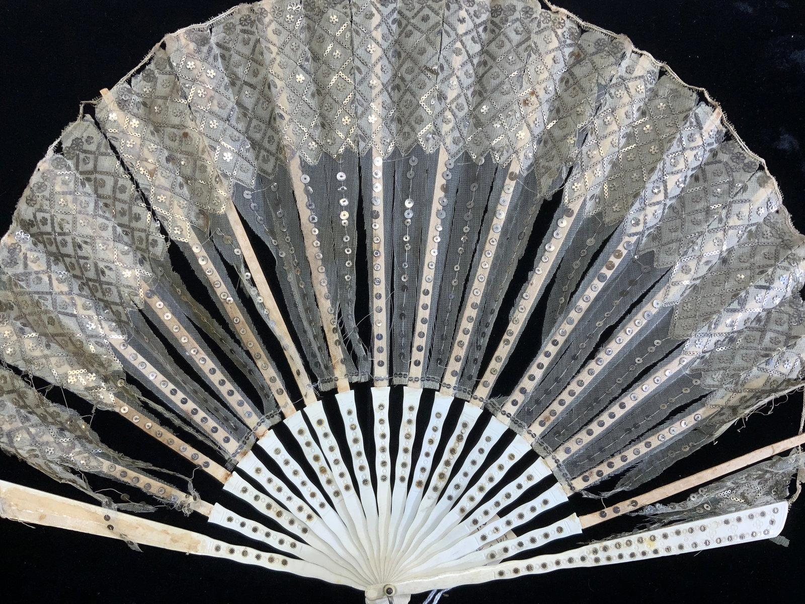Antique Bone & Lace Hand Fan w Sequins: 19th century carved bone hand fan made with lace and hand sewn sequins. All bone sticks are in tact. Metal loop. Wear to lace -separated from sticks. Measures 12.25 in. Long, 16 in. Wide when opened. 