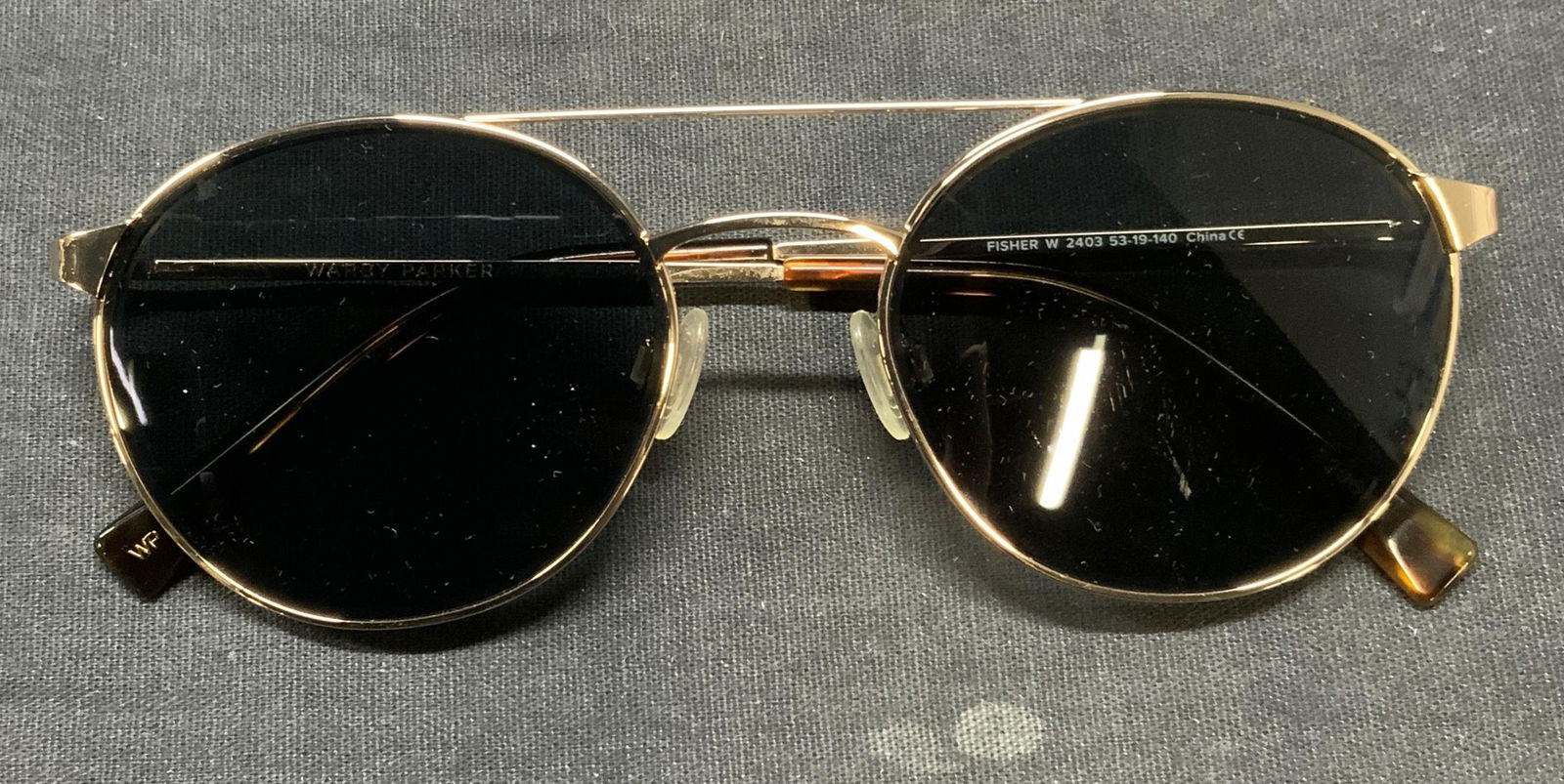 Warby Parker Fisher Aviator Sunglasses: Warby Park gold tone metal and tortoise Fisher aviator sunglasses. Signed on arm. Measure approx. 5 inches wide, arm approx. 5.5 inches. Some wear to frame consistent with exposure. Warby Parker, Warb