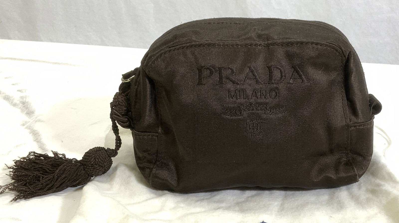 PRADA Milano Italy Satin Make- Up Case w Duster: Chocolate satin PRADA Cosmetic case with tassel. Zipper closure. Prada logo interior in chocolate with signed Plate. Interior lining needs to be re- sewn. Made in Italy. Measures 6.5 in. Wide, 3 in de