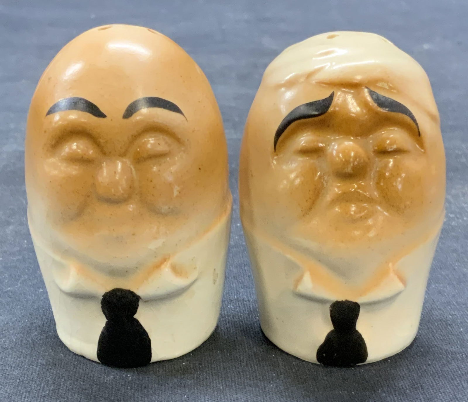 Pair Vintage Porcelain Humpty Dumpty Shakers: Pair of vintage porcelain salt and pepper shakers. Humpty Dumpty hand painted figural motif. Measure approx. 1.75 x 2.75 inches each. Made in Japan. Both pieces have some surface wear including scratc