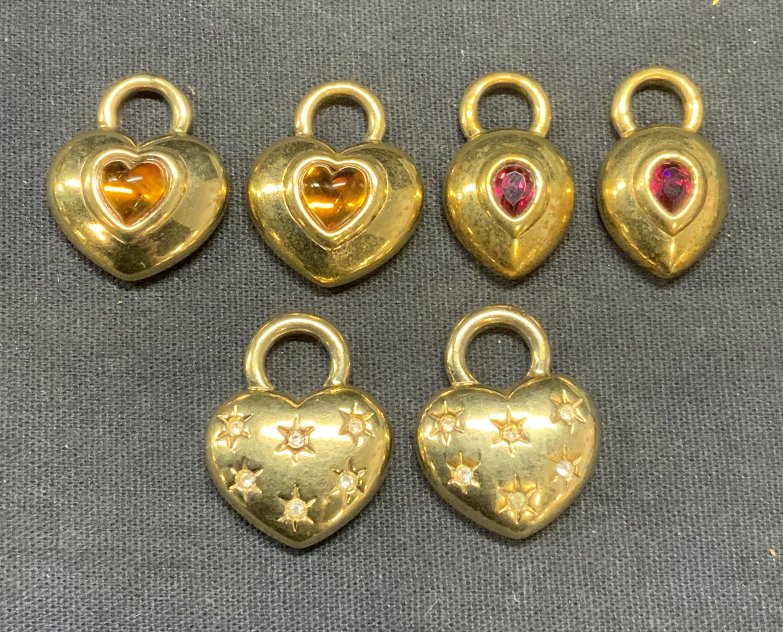Lot 6 Agatha Gold Tone Heart & Drop Pendants: Lot of 6 Agatha gold tone heart and drop shaped pendants. Embossed star pattern, amber tone crystal, and red crystal decoration. All pieces signed to underside. largest pieces measure approx. 1 x .75 