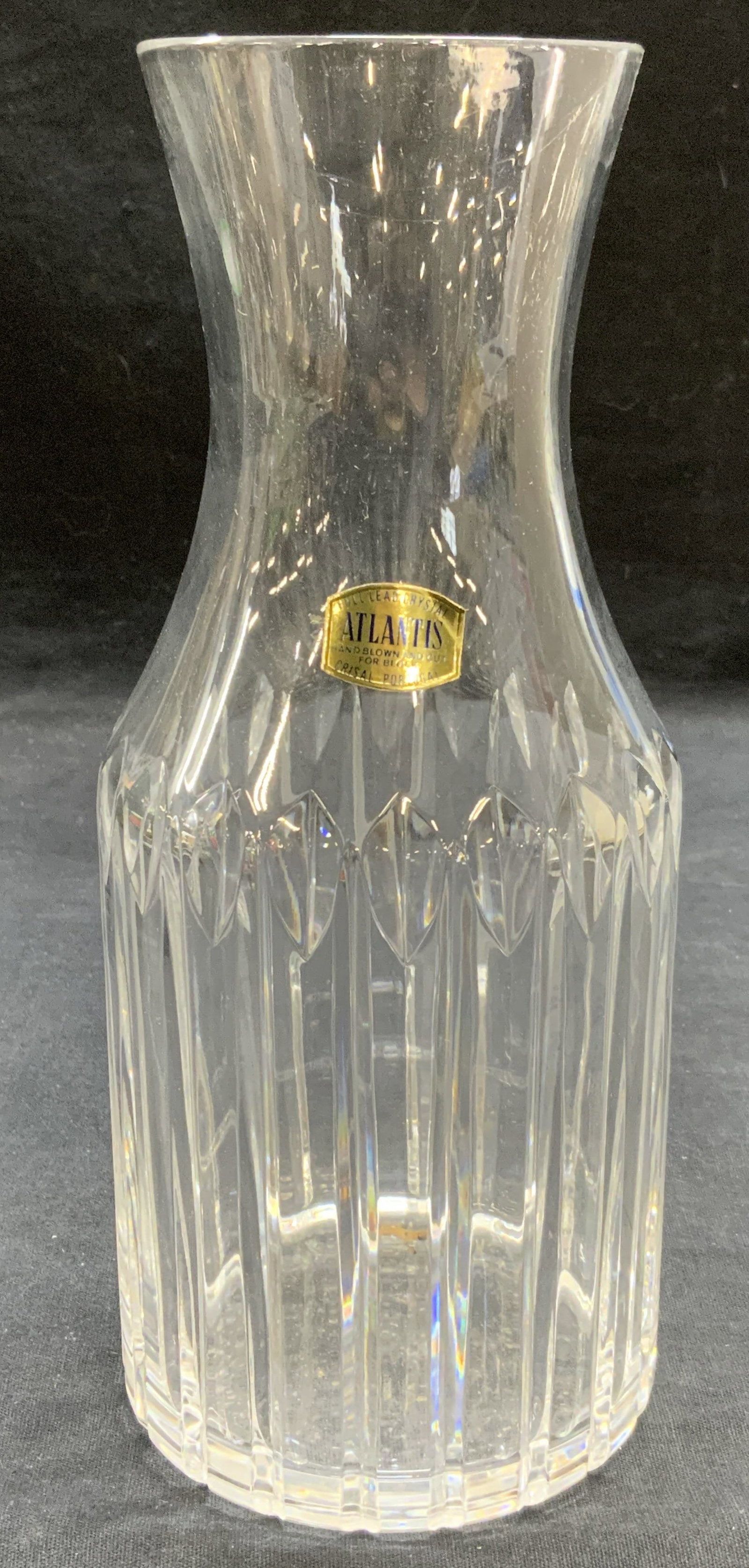 Vintage Atlantis Cut Crystal Carafe Portugal: Vintage Atlantis crystal carafe. Cut crystal with ribbed pattern. Signed on sticker. Made in Portugal. Measures approx. 3.75 x 9 inches. Includes original box. Some surface wear including scratching o