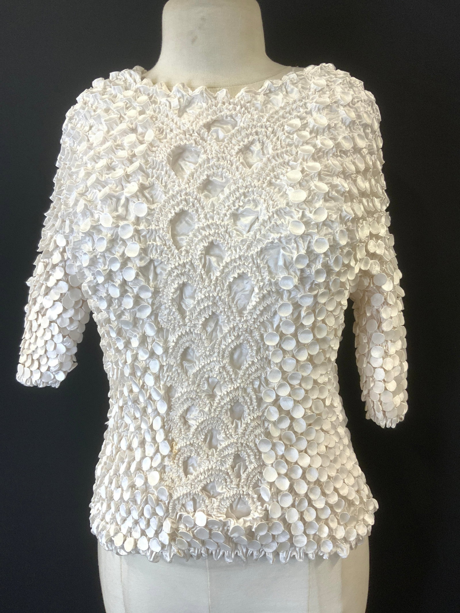 Step in Style Ruched Satin 3/4 Sleeve Blouse: A one size fits most shirt with ruched round and scrunched mountain patterns in white polyester satin. 3/4 sleeves. Expands to fit your size. This is a boutique blouse by designer Step in Style. origi